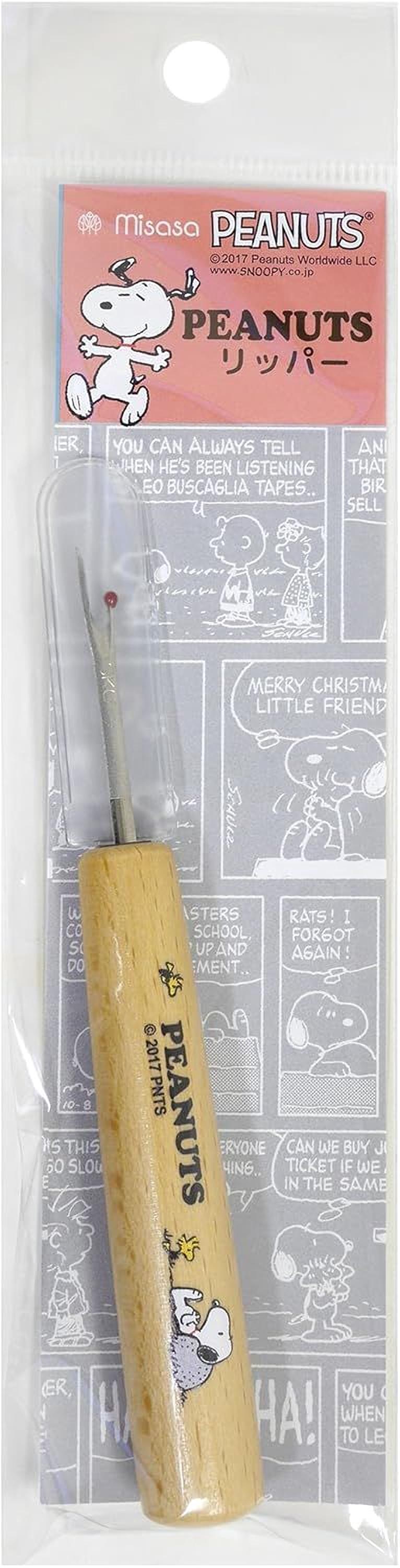 a Peanuts-themed sewing tool, specifically a Peanuts-branded scissors, with a wooden handle and a cartoon Peanuts character on the handle.
