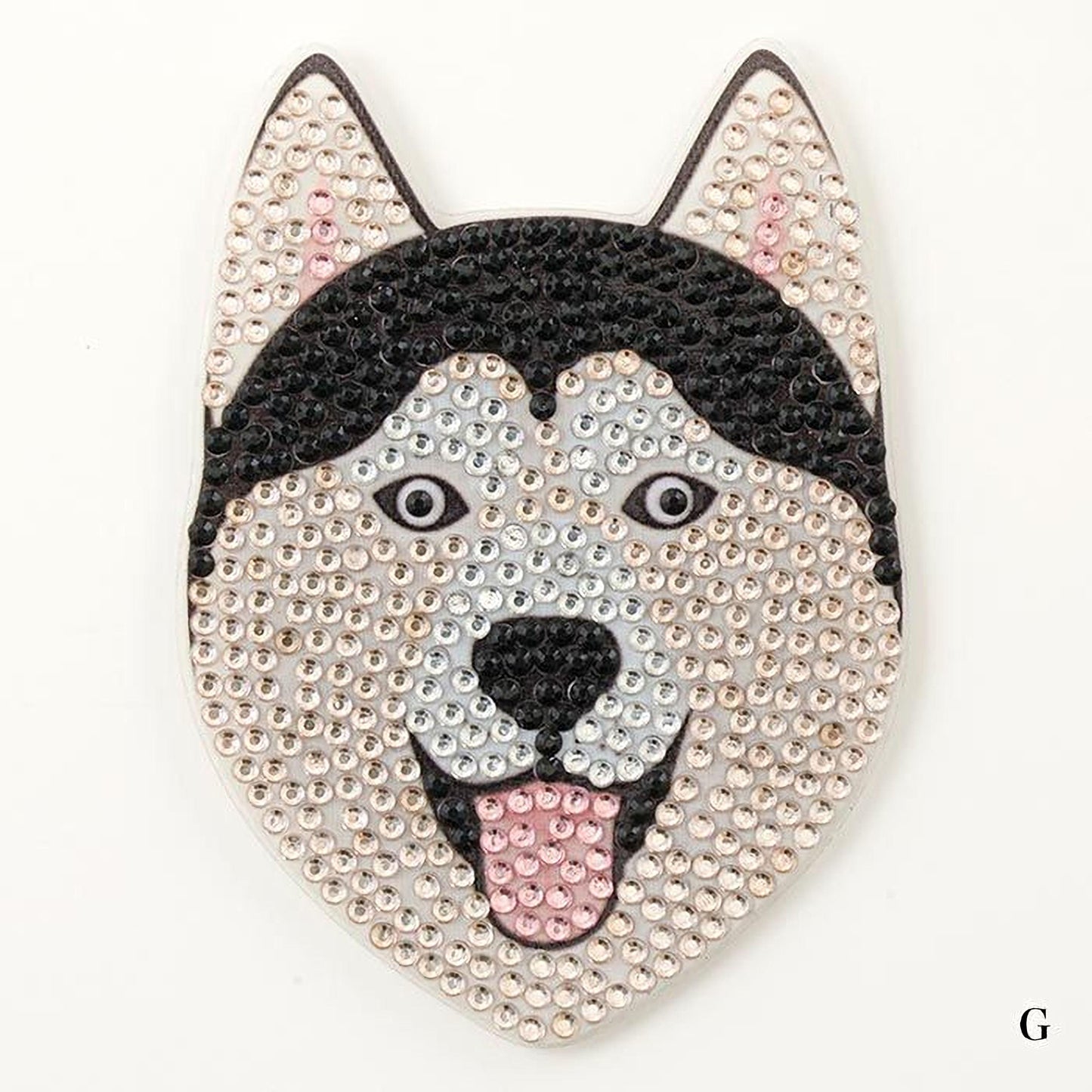 A close-up of a dog's head made of rhinestones, with a black and white color scheme.
