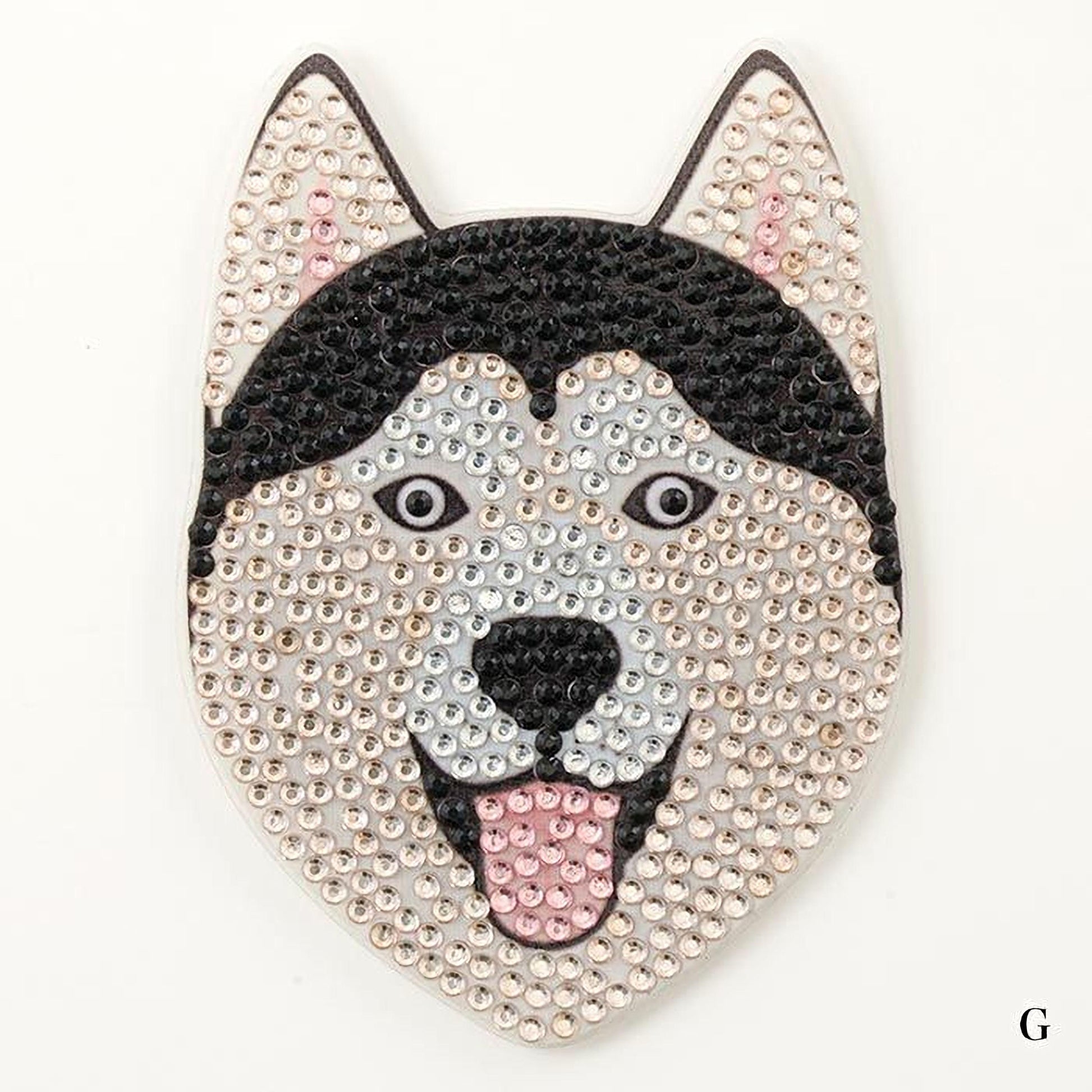 A close-up of a dog's head made of rhinestones, with a black and white color scheme.