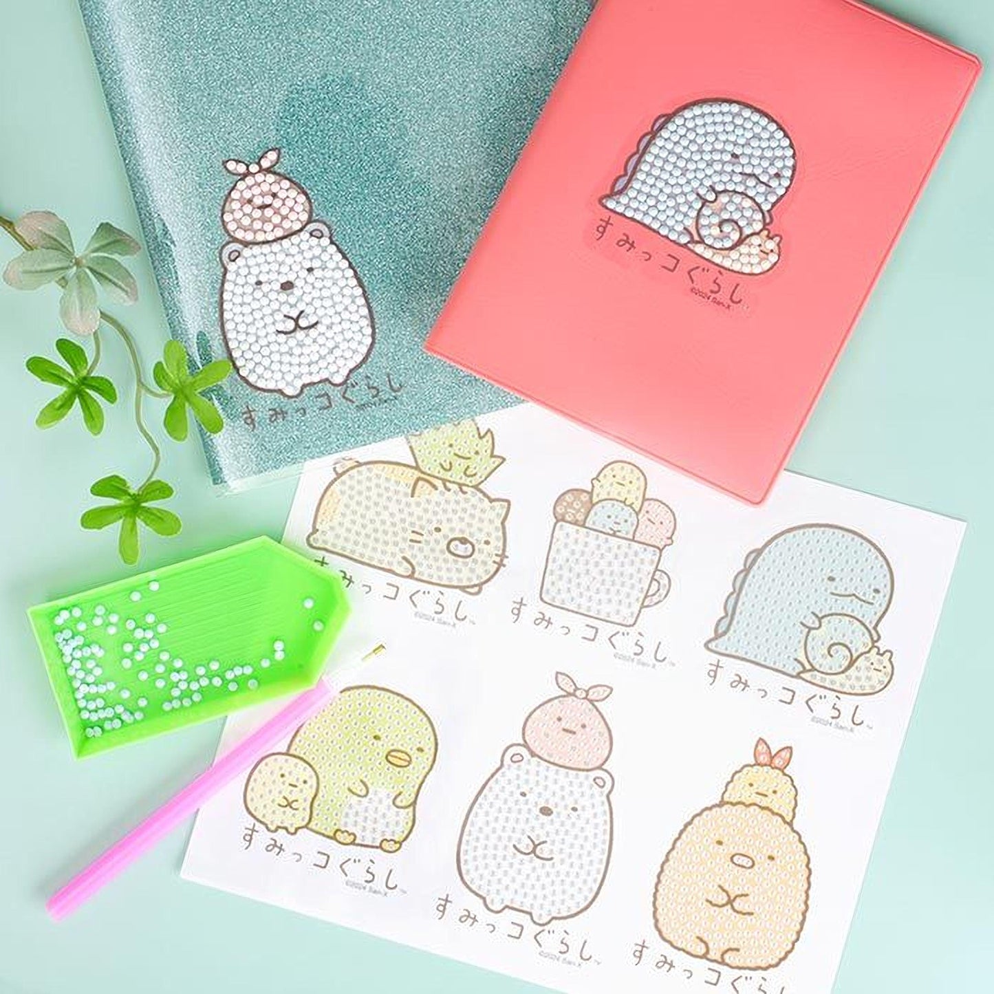a collection of colorful, cartoon-style animal illustrations, including a bear, a cat, a dog, and a turtle, along with a pink notebook and a green magnifying glass.
