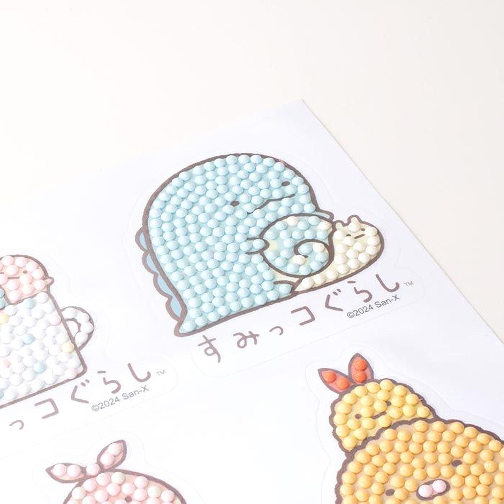 a collection of cartoon-style stickers or illustrations, each featuring a different animal or character. The stickers are arranged on a white surface, and there is text visible in the image.