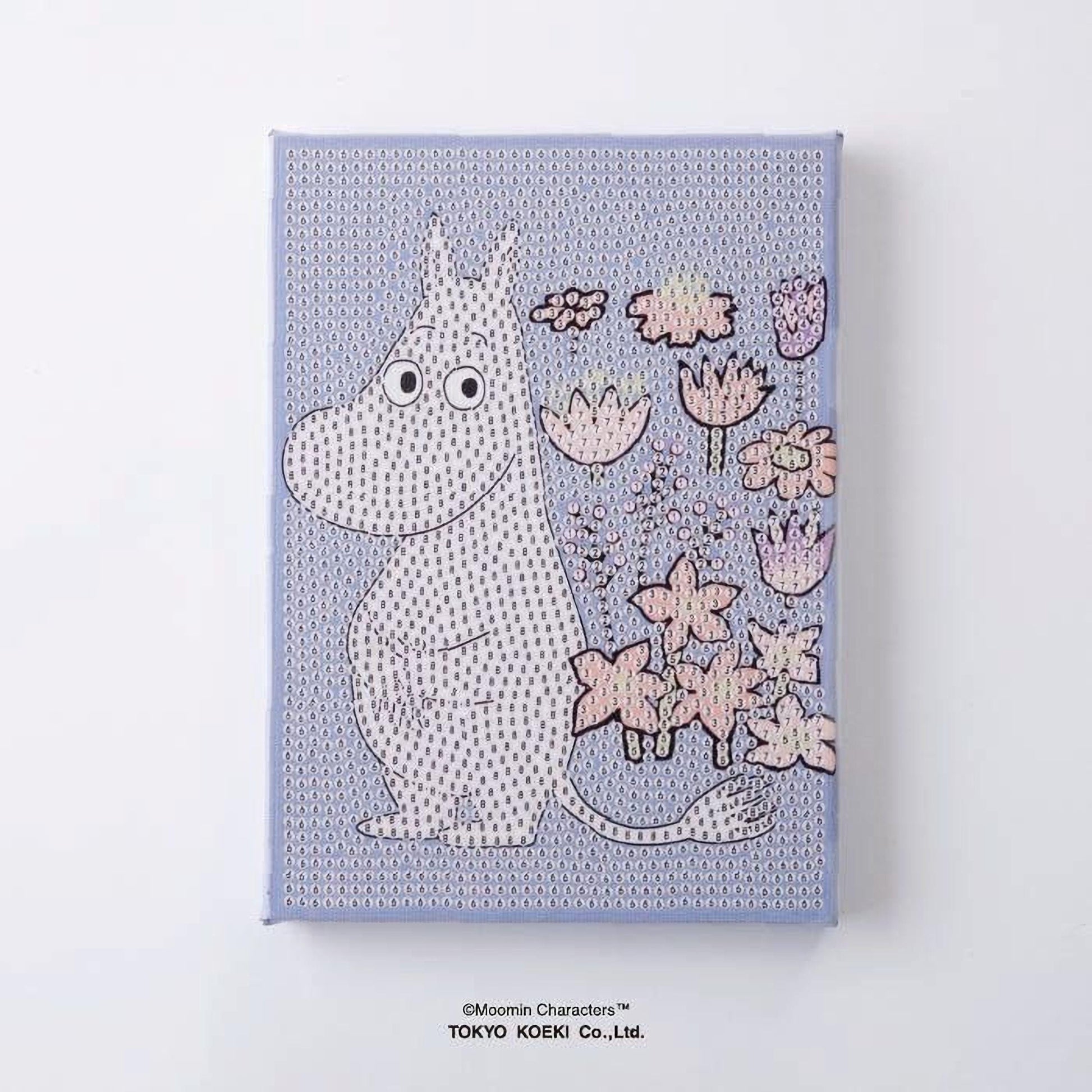A canvas print featuring a cartoon character resembling Moomin from the Moomin characters series, with a background of various flowers and plants.