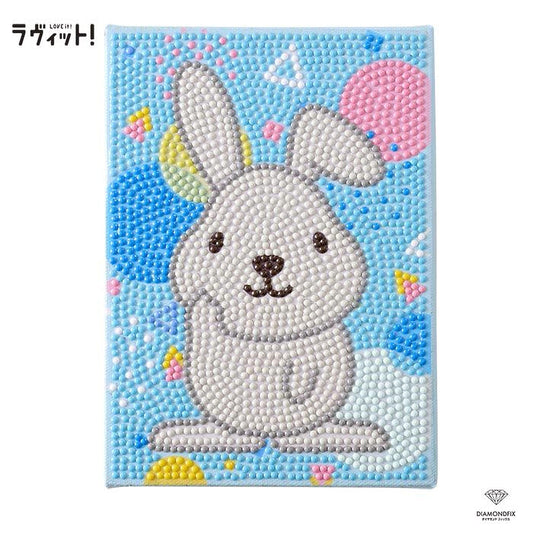 A colorful and playful image featuring a cartoon rabbit surrounded by various shapes and patterns in shades of blue, pink, and yellow.
