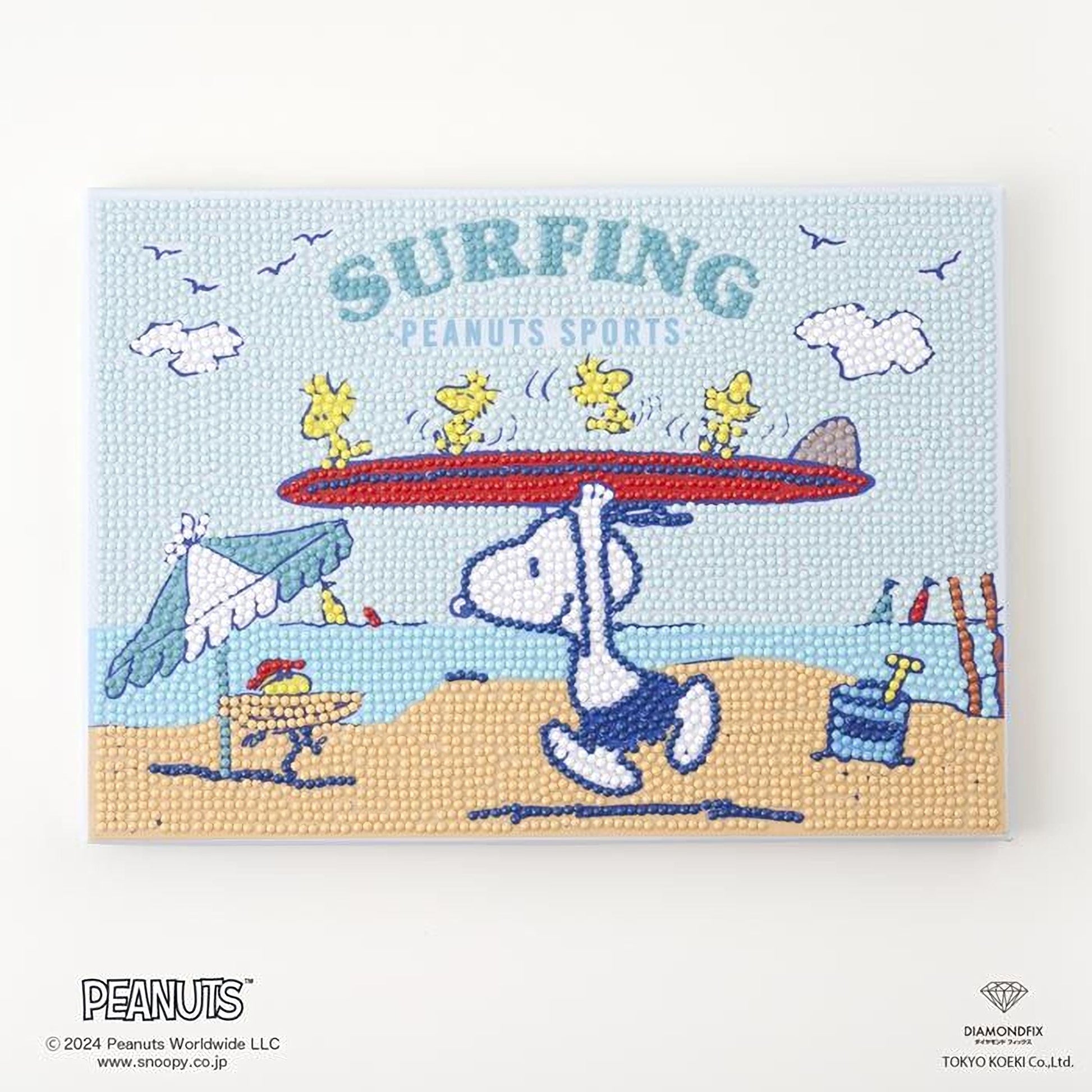 A cartoon image of a character holding a surfboard, with the text "Surfing Peanuts Sports" and a beach scene with other characters and objects.
