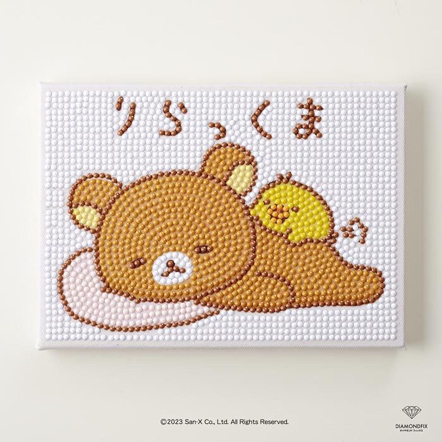 A diamond-studded canvas featuring a cartoon image of a brown bear and a yellow bird, with Japanese text above the bear.