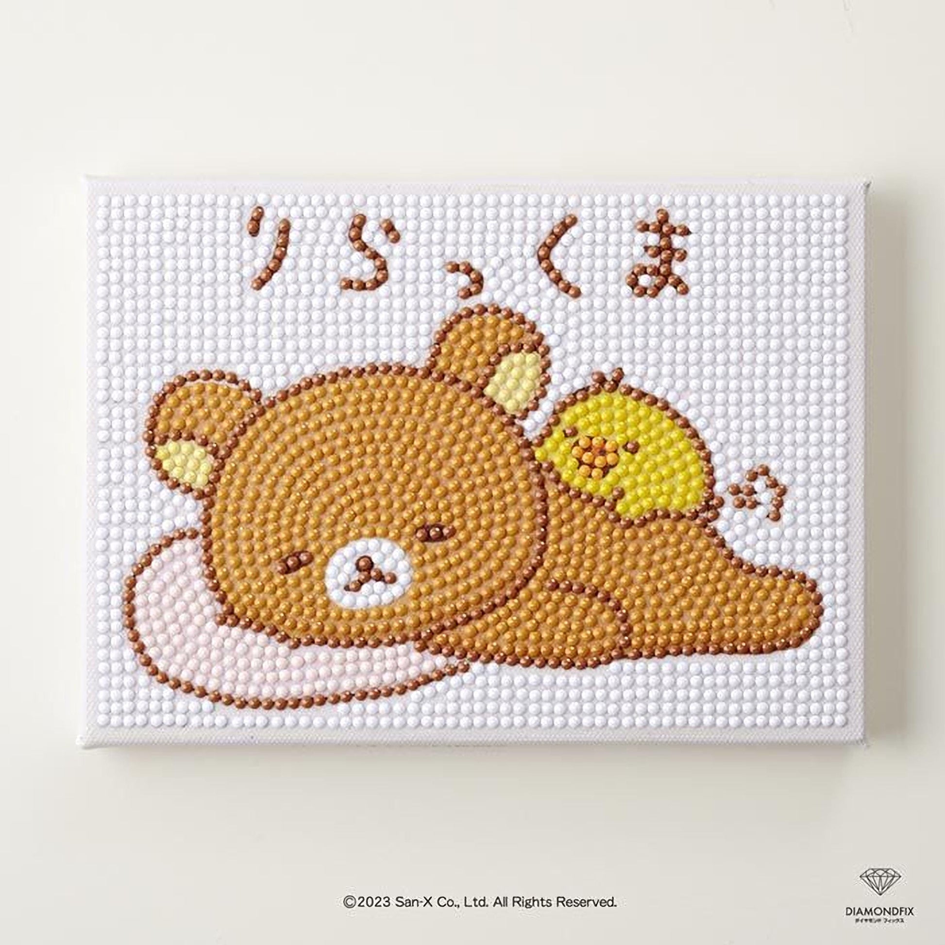 A diamond-studded canvas featuring a cartoon image of a brown bear and a yellow bird, with Japanese text above the bear.