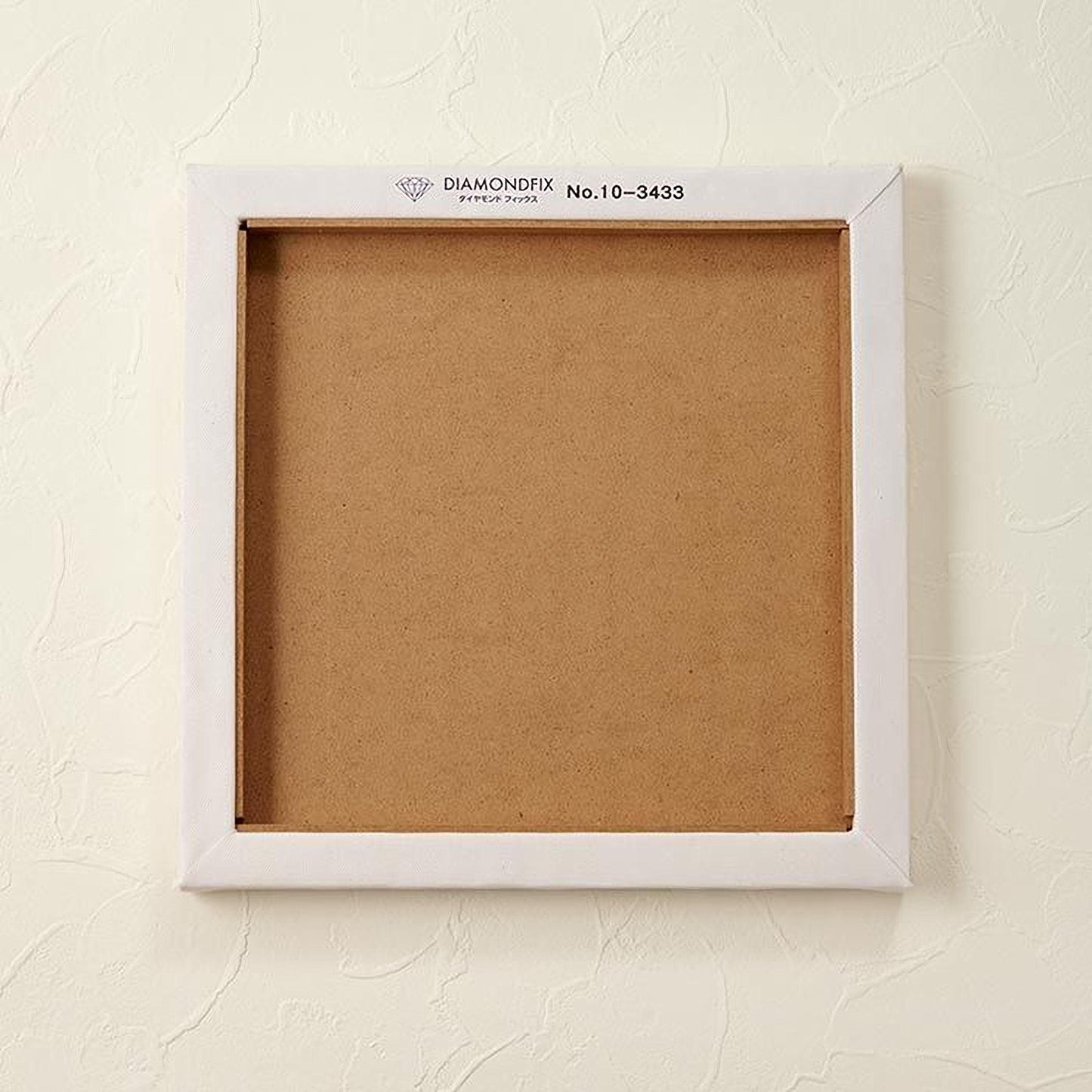A white square frame with a blank canvas inside, mounted on a white wall.