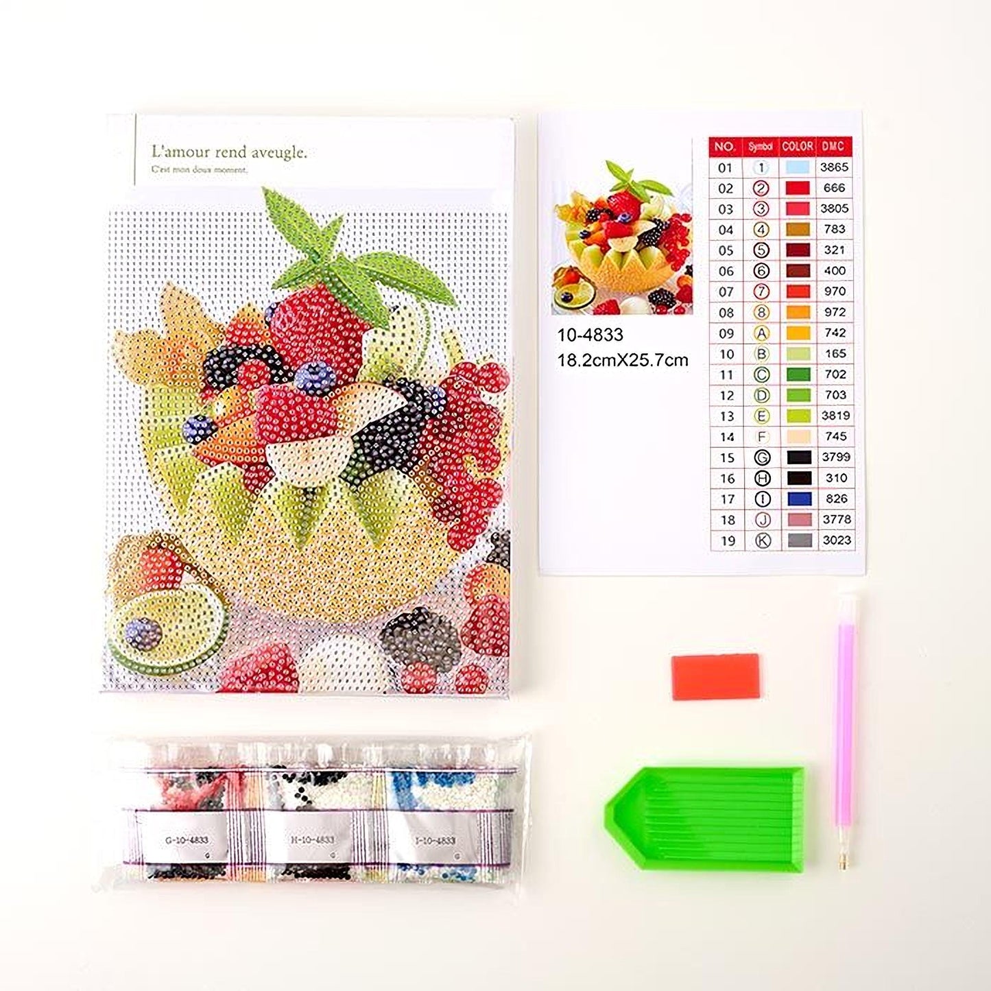 various items related to a fruit-themed embroidery kit, including a book with a fruit design, a set of embroidery needles, a set of embroidery floss colors, and a pattern for creating a fruit design.