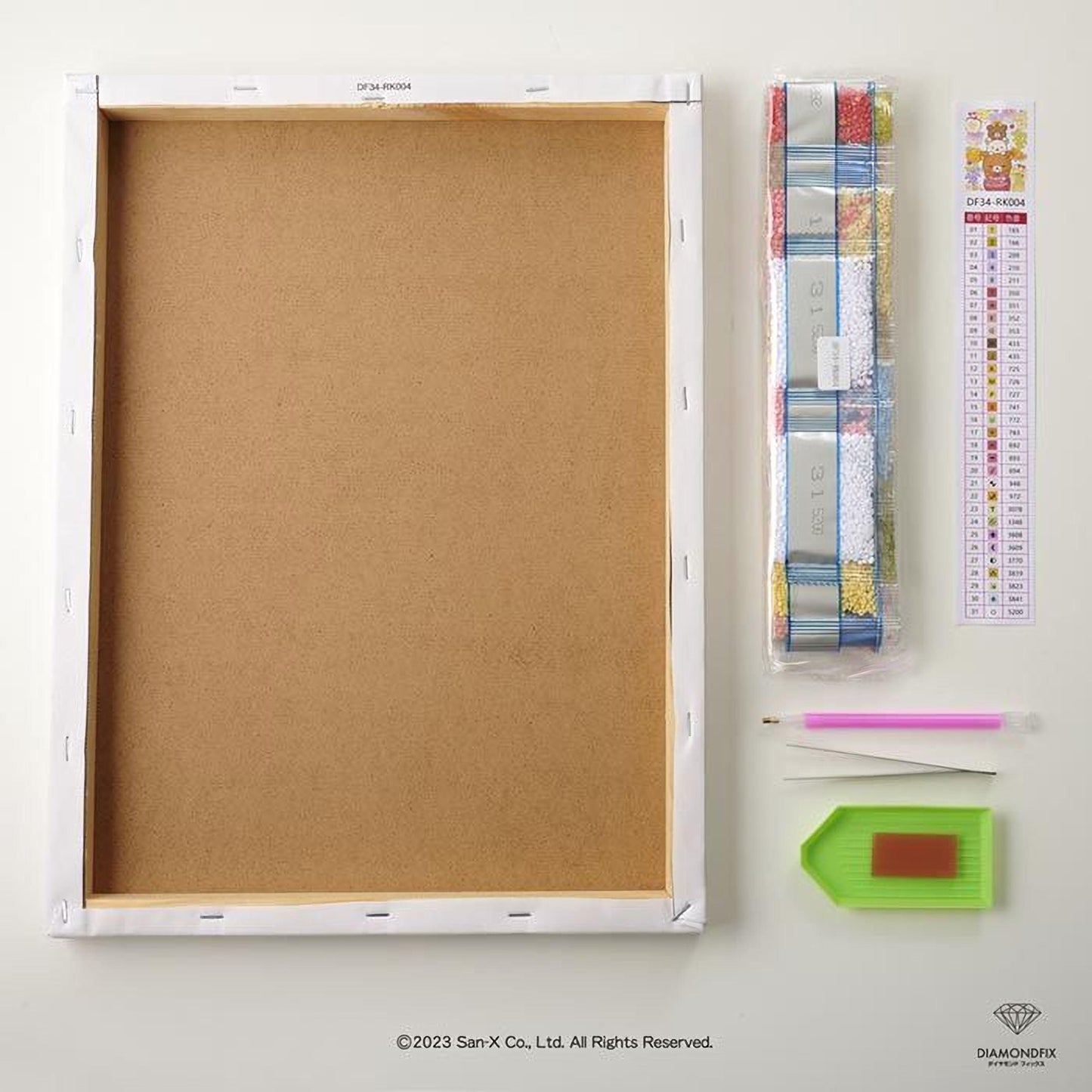 a blank canvas, a ruler, a diamond-shaped tool, and a set of diamond-shaped tools, all arranged on a white surface.