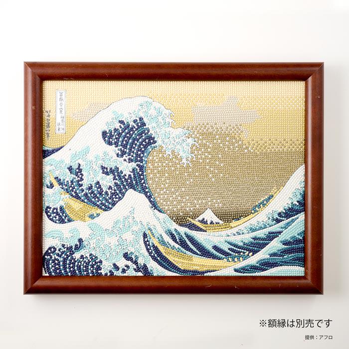The image is a framed painting depicting the famous Japanese woodblock print "The Great Wave off Kanagawa" by the artist Hokusai.