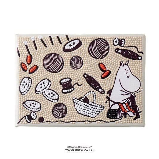 The image is a collage of various embroidered and bead designs, including a character, buttons, yarn, and other decorative elements.