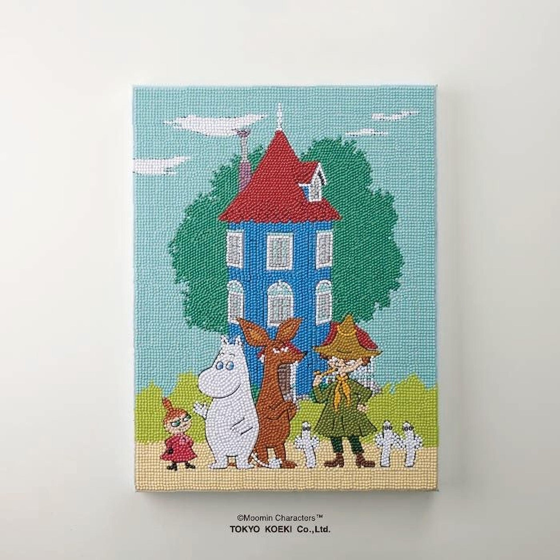 The image is a colorful painting depicting a whimsical scene with a blue house, a tree, and various cartoon characters, including Moomin characters.