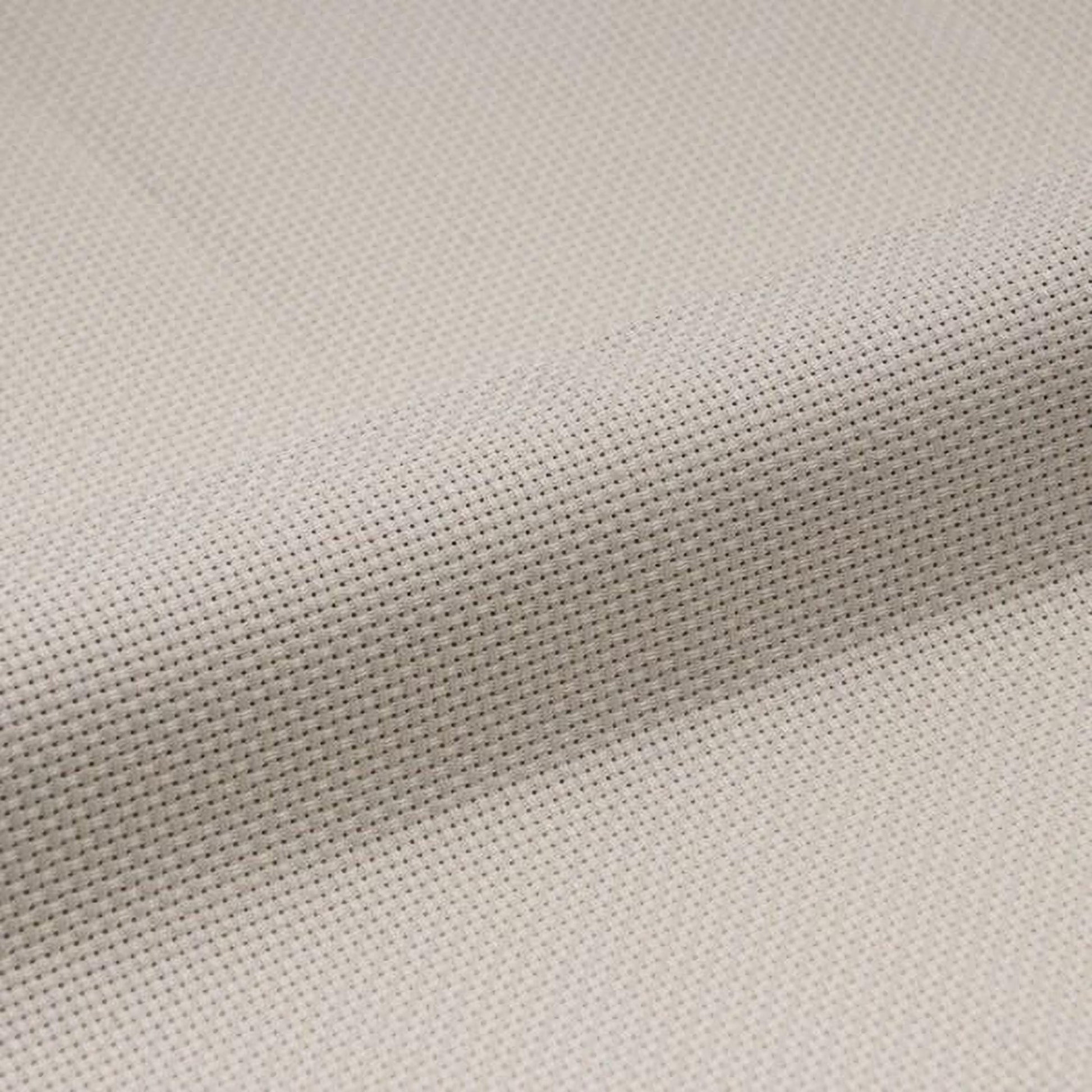 a close-up view of a fabric with a cross-stitch pattern, featuring a light beige color.