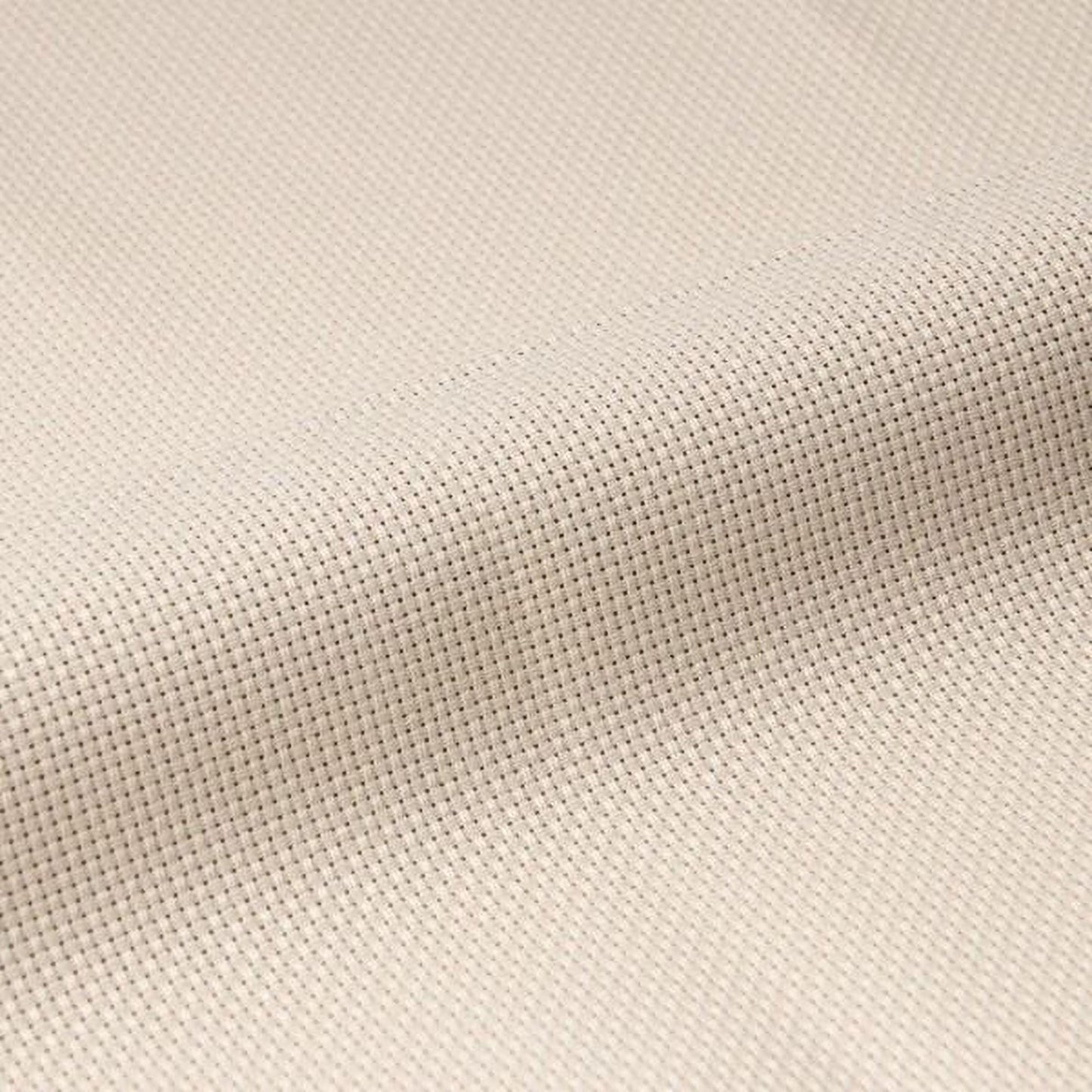 A close-up image of a fabric with a criss-cross pattern, featuring small white dots arranged in a diagonal pattern.