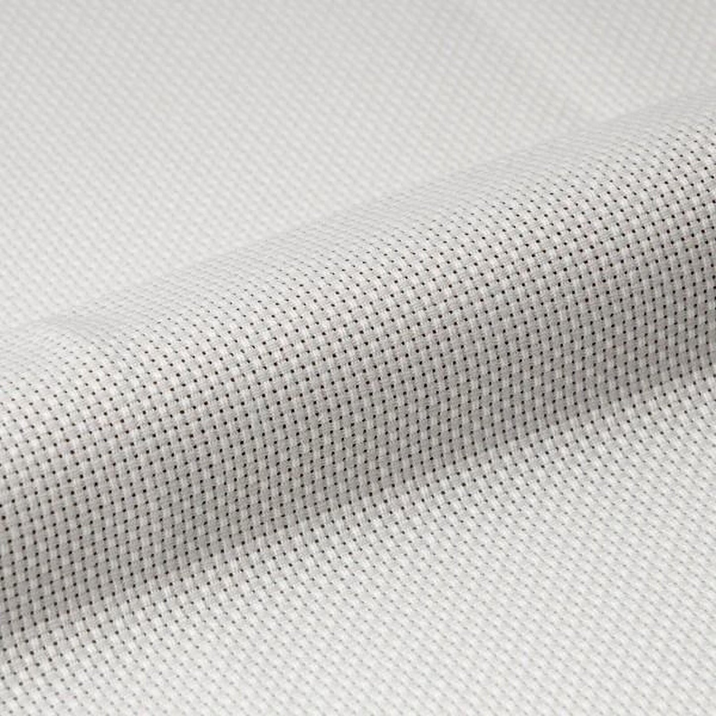 A close-up view of a white fabric with a textured, woven pattern.