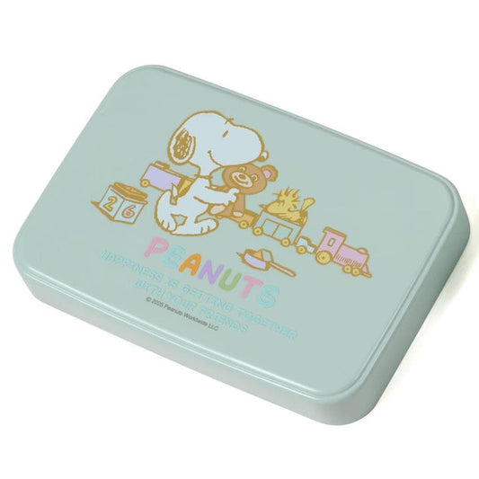 A light blue rectangular container with a cartoon image of a character from the Peanuts comic strip, holding a teddy bear and a train.