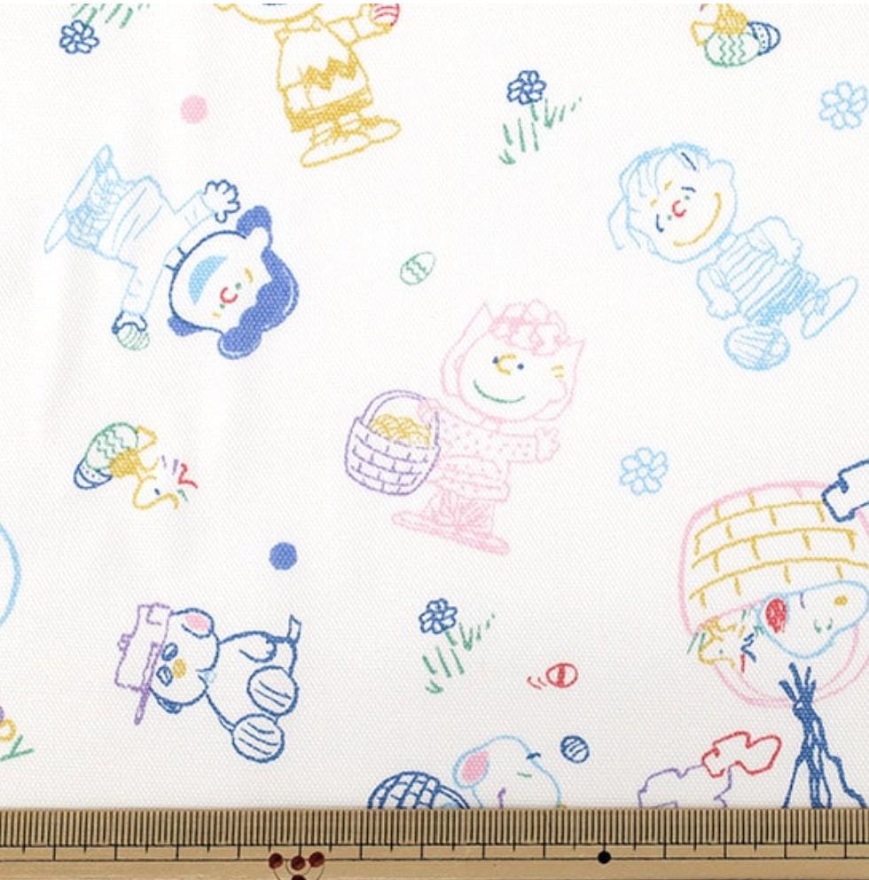 The image is a fabric with a repeating pattern of cartoon characters, including Peanuts characters, such as Charlie Brown, Snoopy, and Woodstock. The characters are depicted in various poses and actions, creating a lively and playful design.