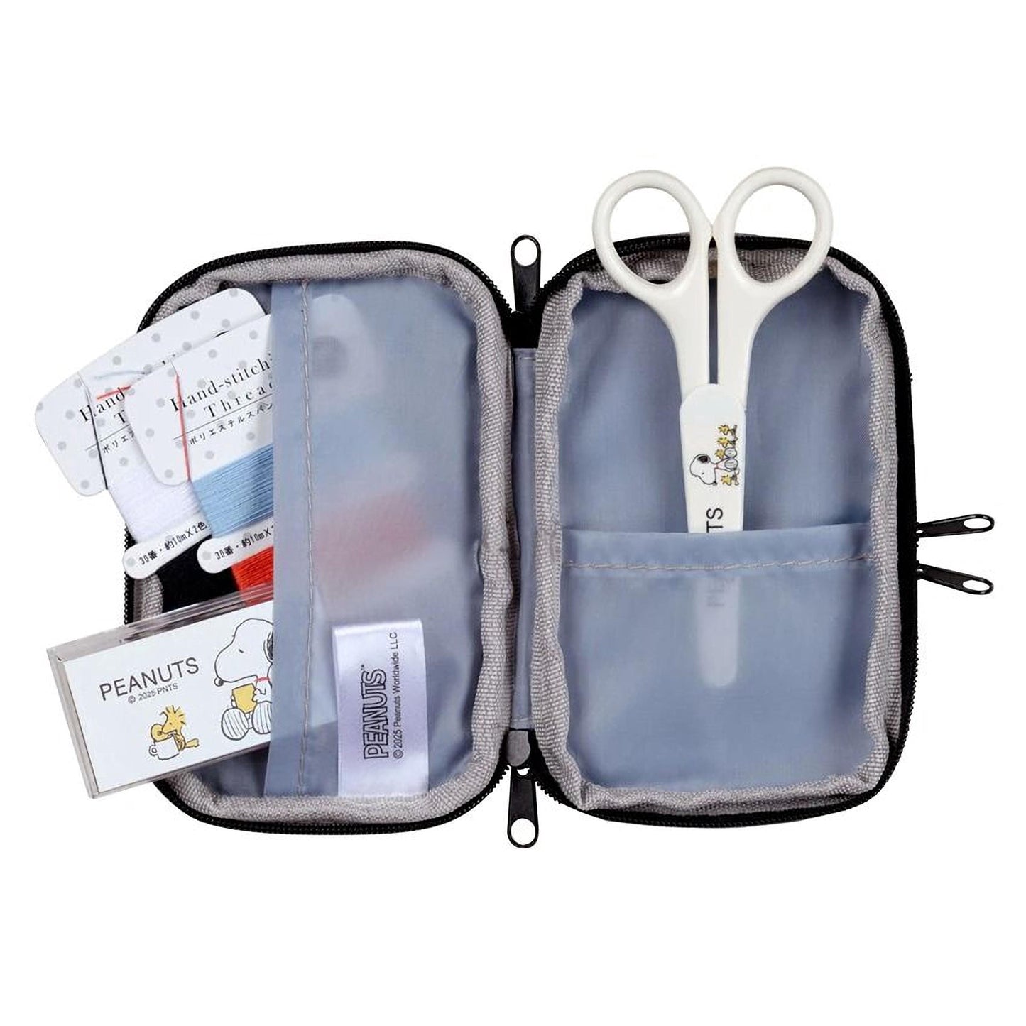 A sewing kit containing a pair of scissors, thread, and other sewing tools, as well as a Peanuts-themed label.