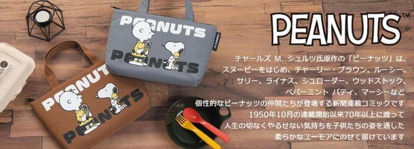 two Peanuts-themed bags, one brown and one gray, placed on a wooden surface alongside various Peanuts-related items such as a plate, a fork, and a spoon.