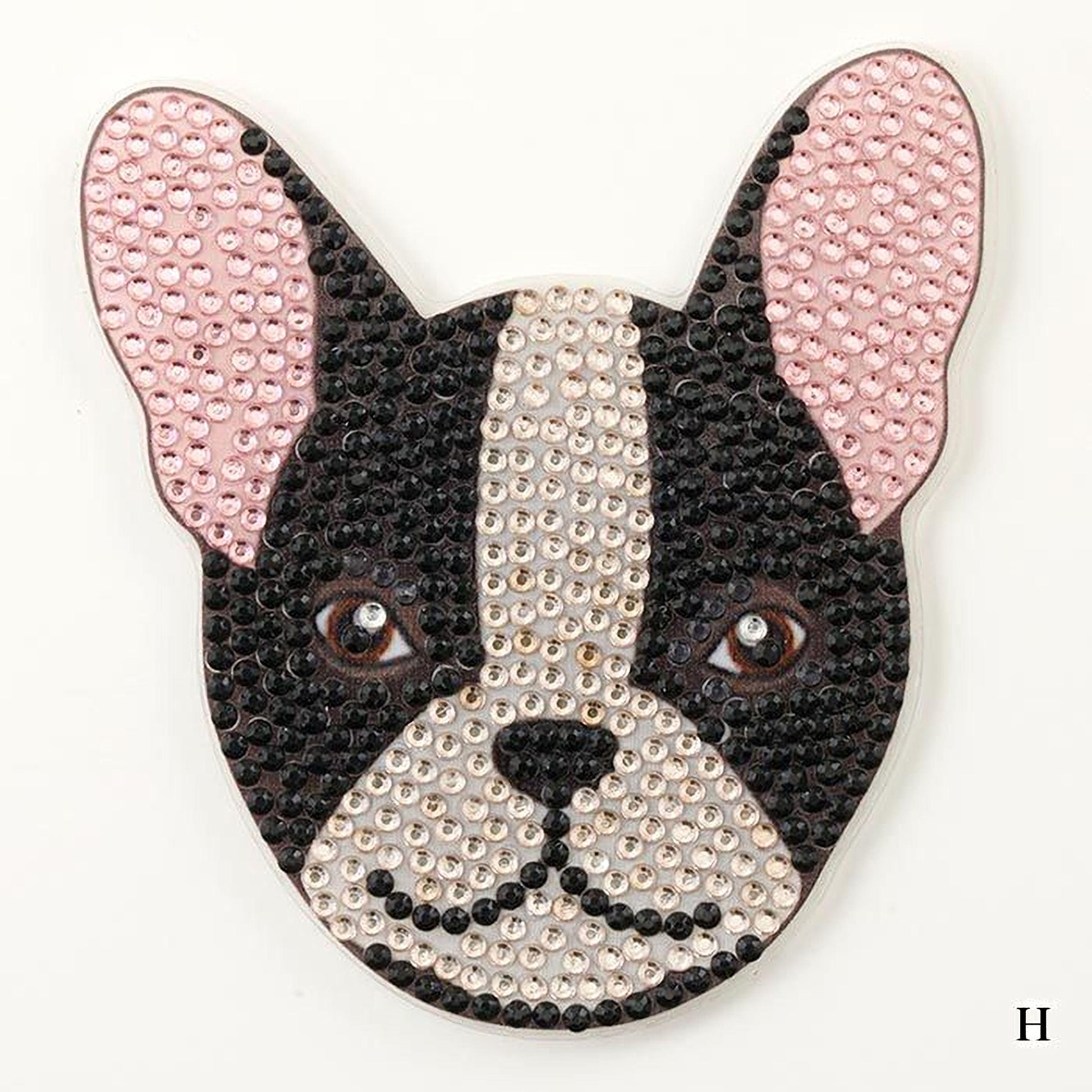 A close-up of a dog's head made of small, sparkling rhinestones in various colors, including pink and black.