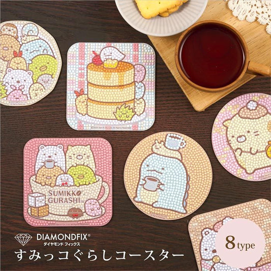 a collection of colorful coasters and a cup of tea, all decorated with cute cartoon characters.