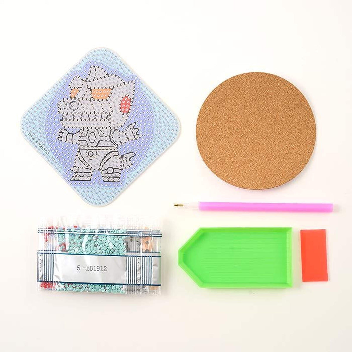 various craft supplies, including a blue and white patterned object, a cork coaster, a pink and purple pen, a green and pink plastic tray, and a package of beads.