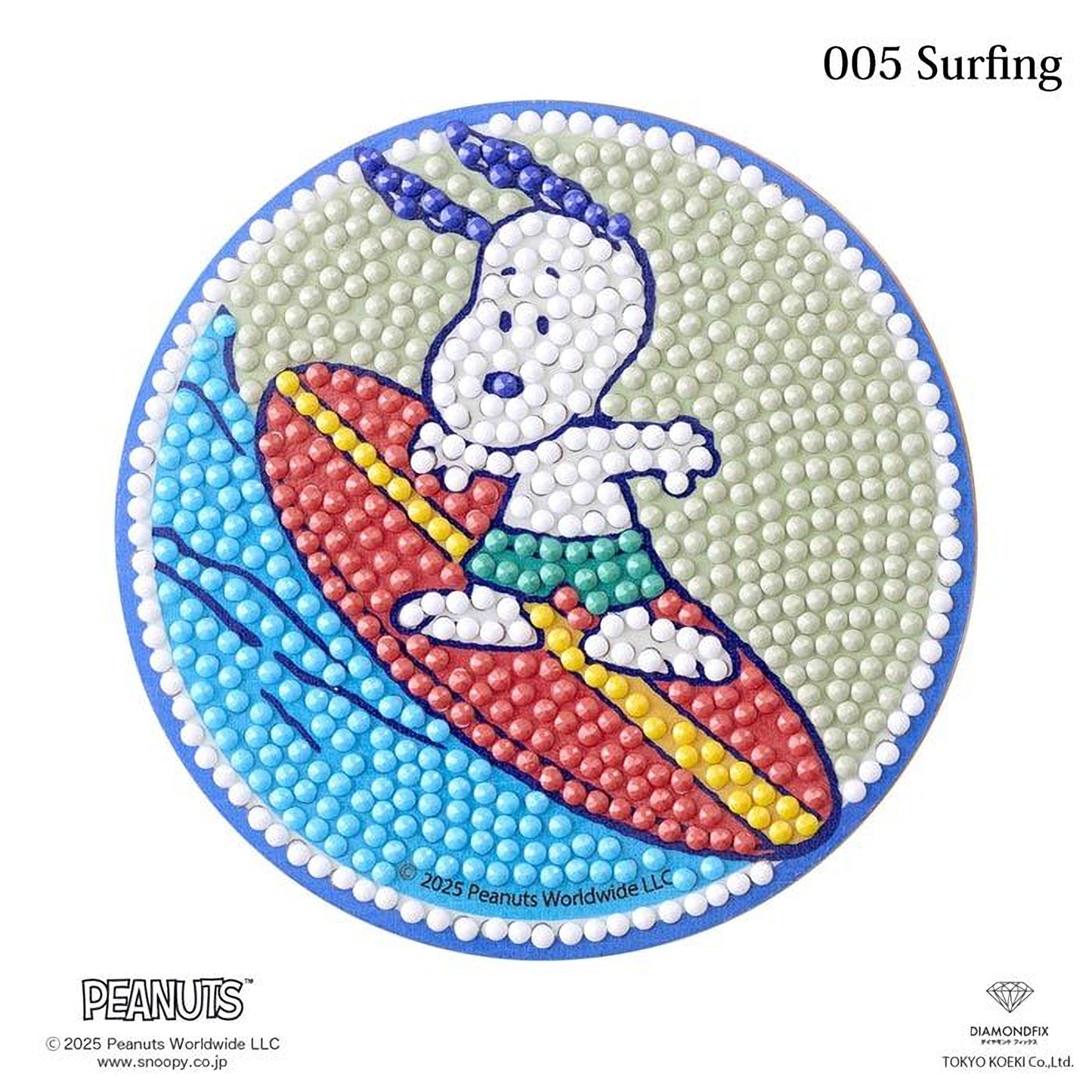A circular design featuring a cartoon character, likely a character from the Peanuts comic strip, riding a surfboard on a wave. The character is wearing a red and yellow striped shirt and green shorts. The design is composed of small dots, and the background is a light blue color.