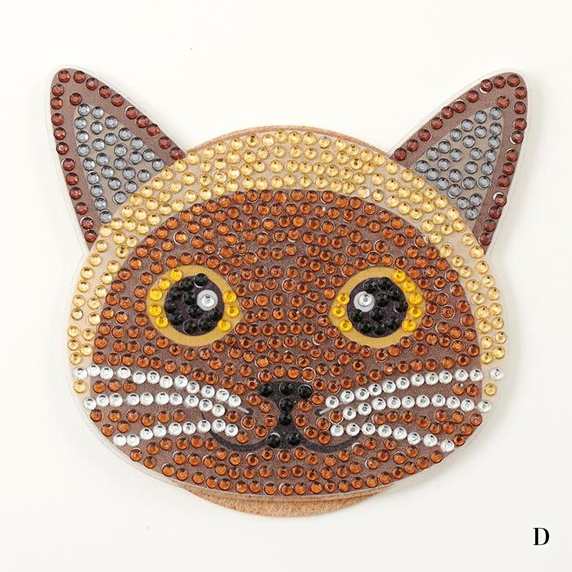 A close-up of a cat-shaped object made of sequins, featuring large, round eyes and a pointed nose.