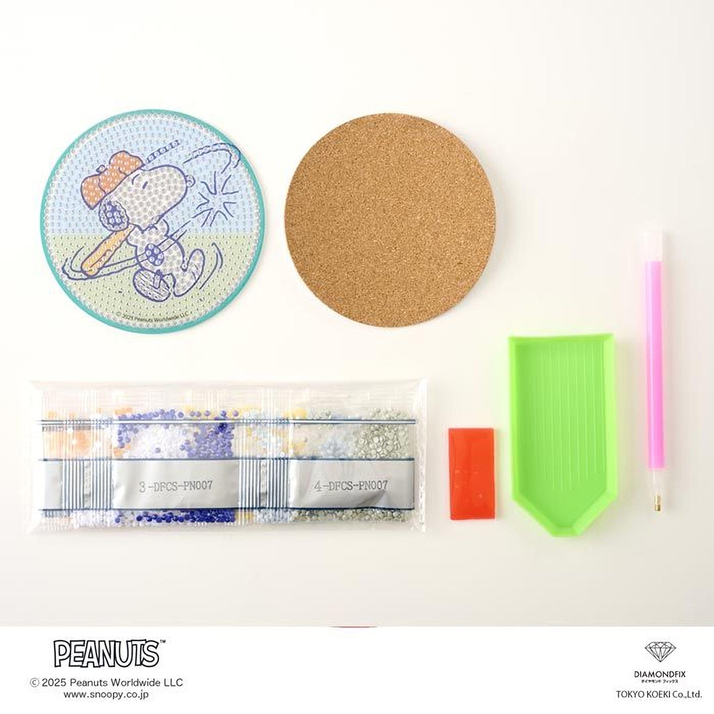 various Peanuts-related items, including a Peanuts-themed coaster, a cork coaster, a pen, a magnifying glass, a magnifying glass, and a magnifying glass.