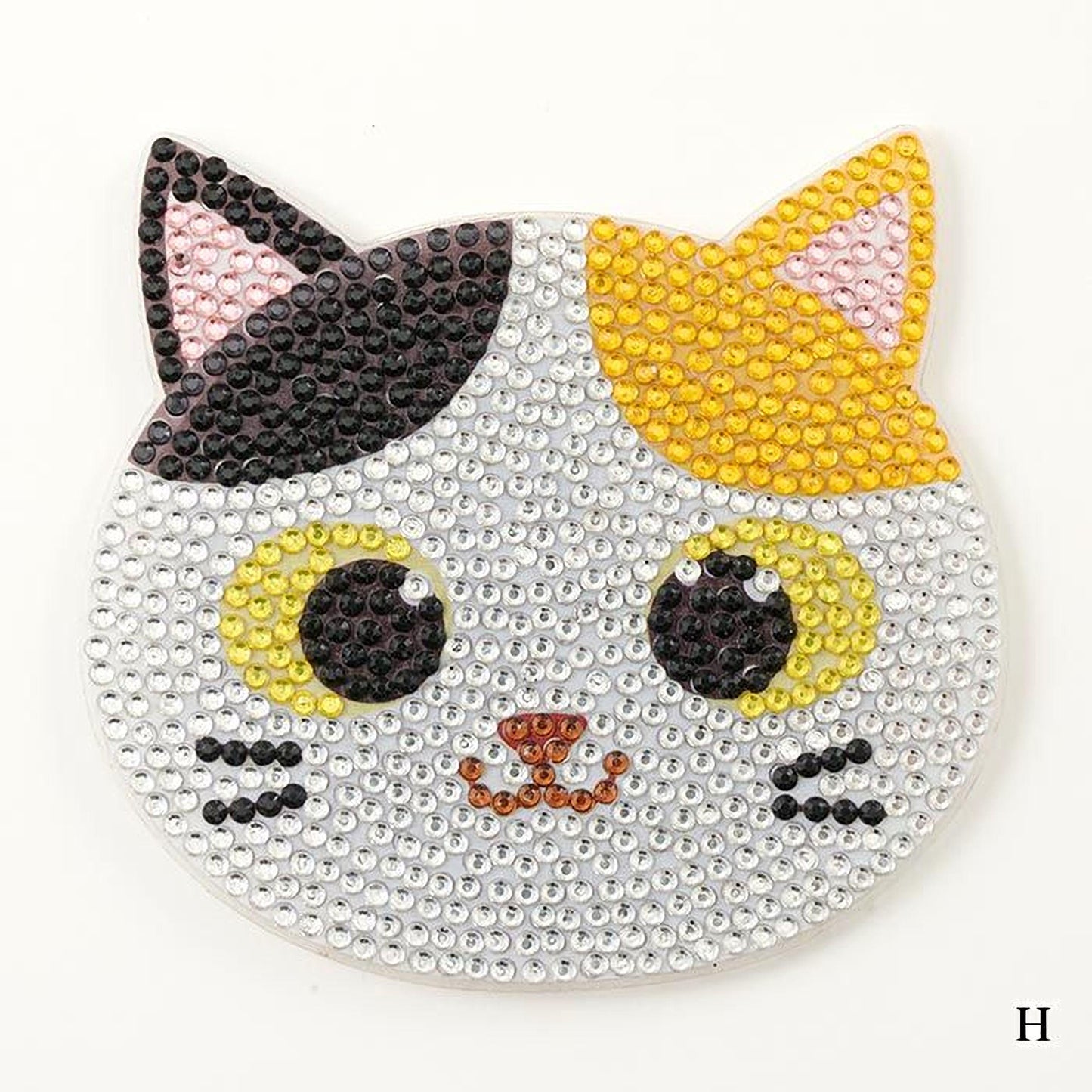 A decorative cat-shaped object made of small, sparkling rhinestones or crystals, featuring a combination of black, yellow, and white colors.