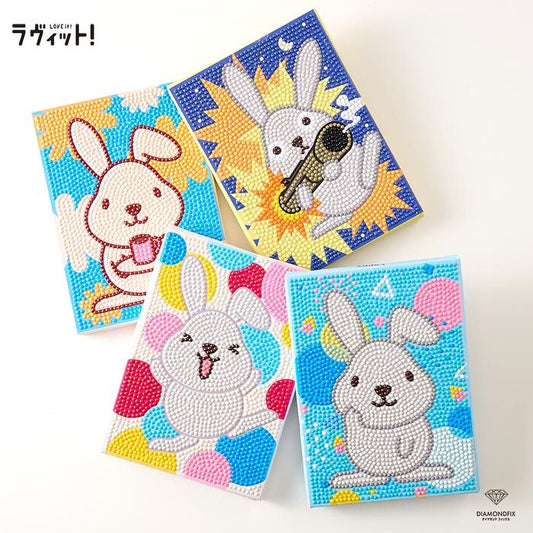 four colorful, hand-painted notebooks featuring cartoon rabbit designs.