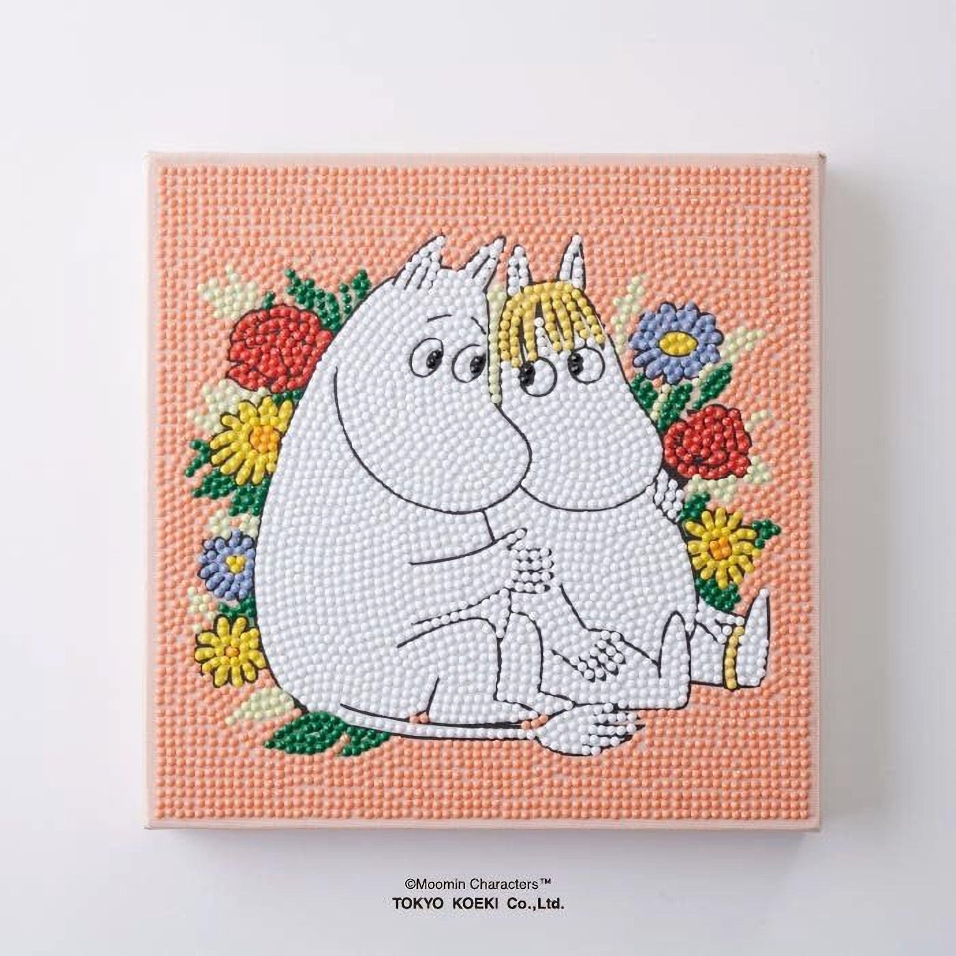 A collage of various images depicting Moom characters, including two white characters with flower-like patterns on their heads, surrounded by colorful flowers and leaves.