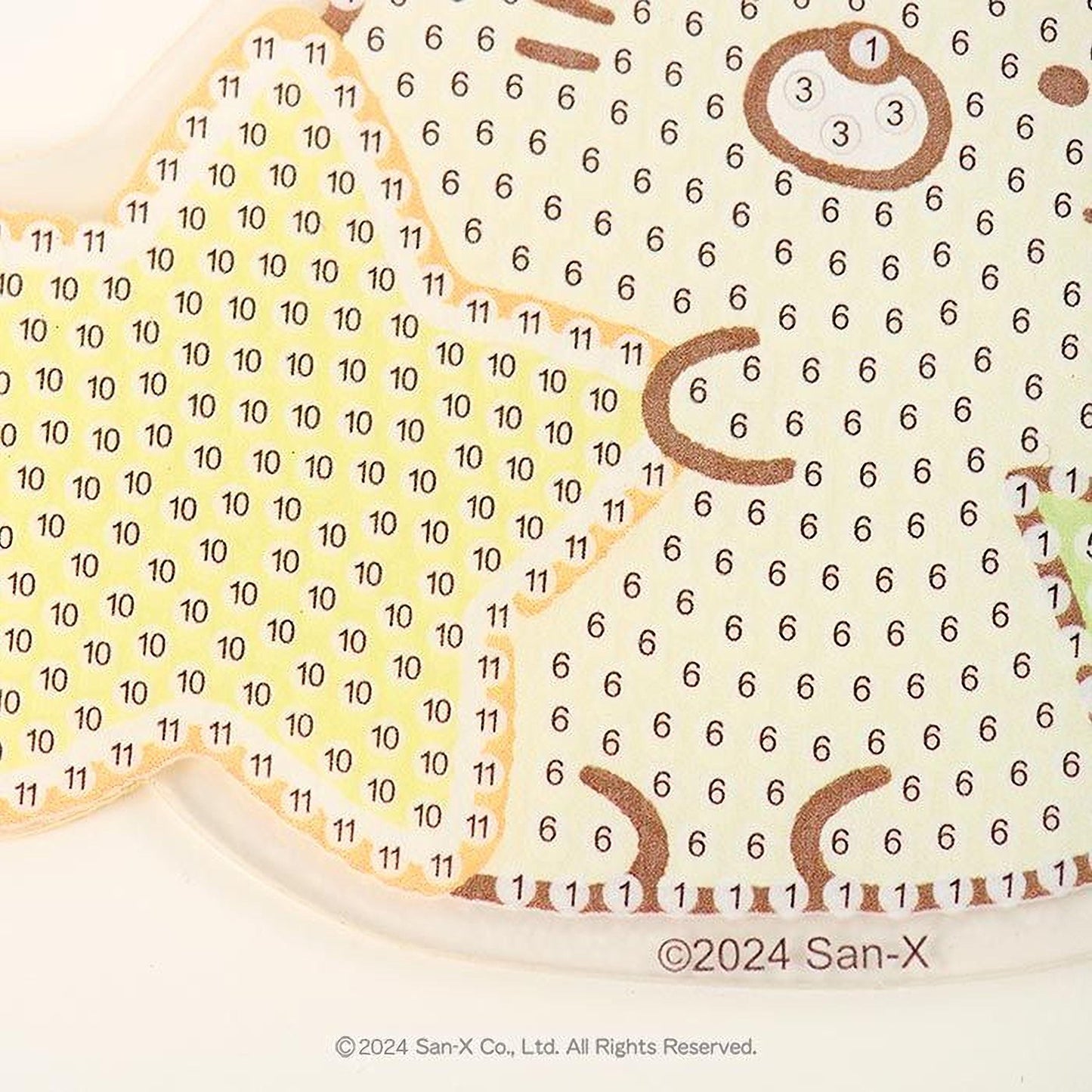 The image is a close-up of a pattern with numbers and shapes, possibly a painting or a design.