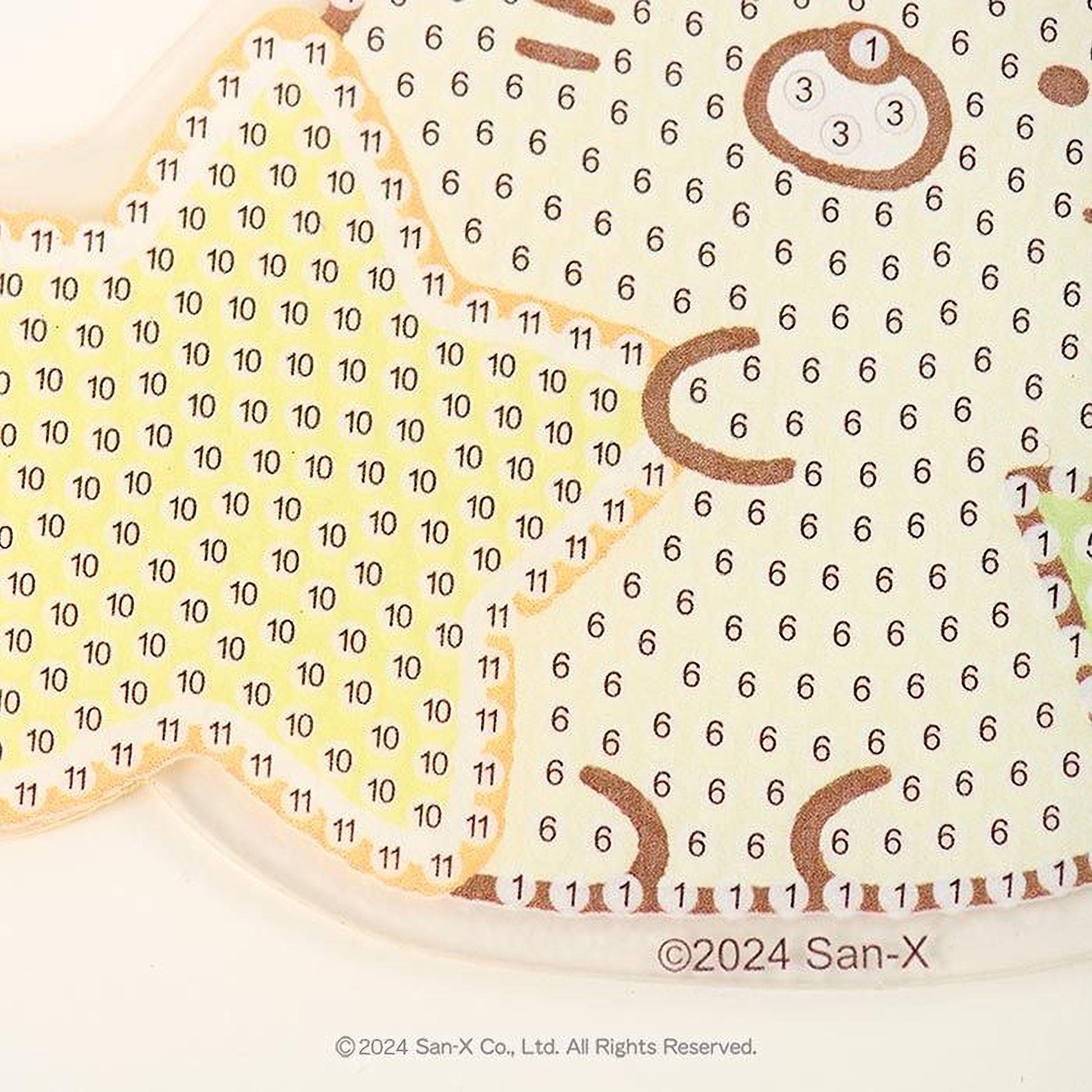 The image is a close-up of a pattern with numbers and shapes, possibly a painting or a design.