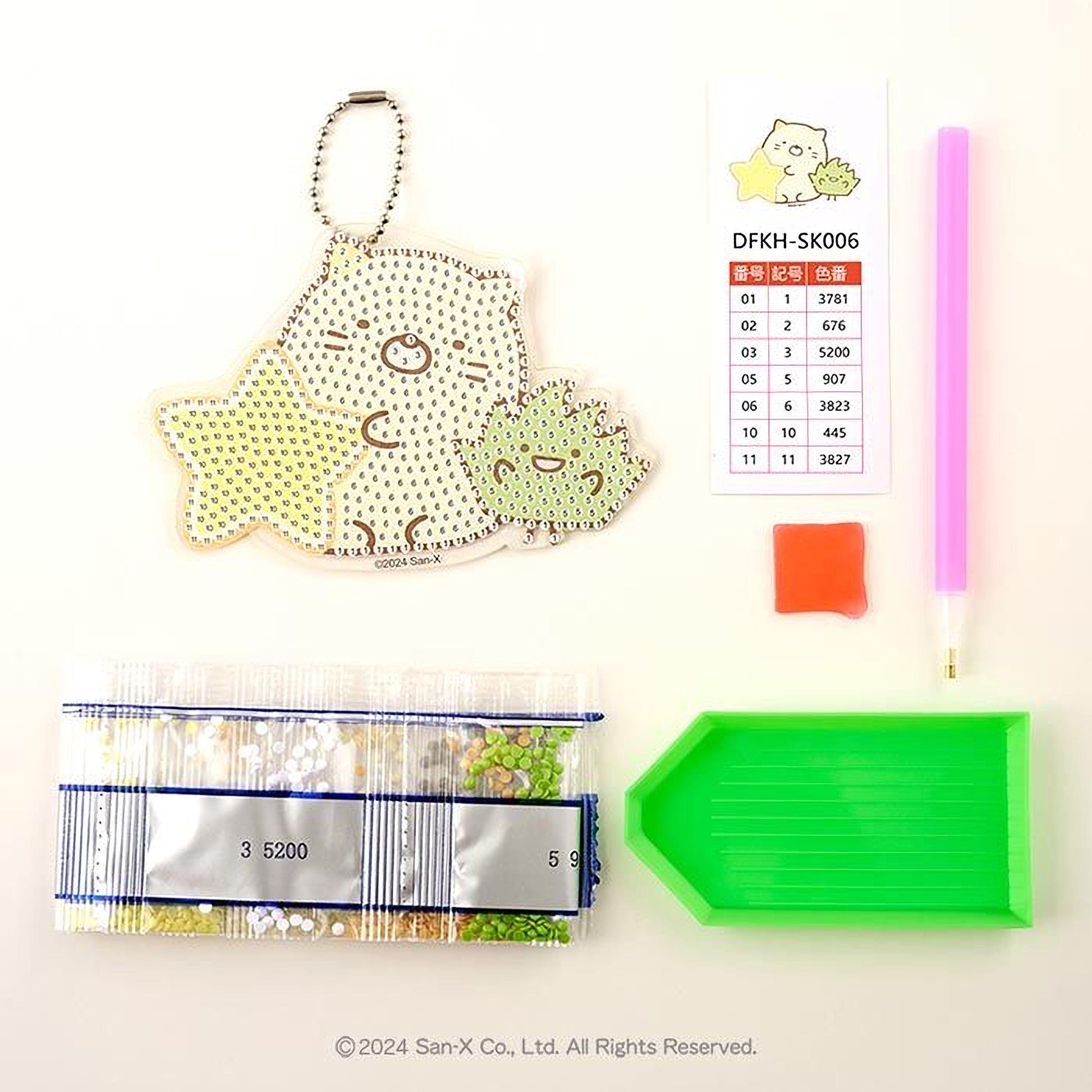 various items related to a craft or hobby, including a keychain, a price list, a pen, a magnifying glass, and a package of beads.