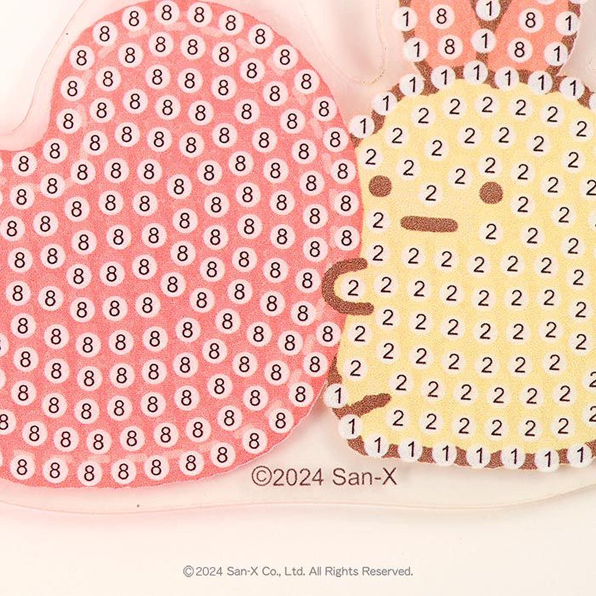 a heart-shaped object with a pattern of small circles and numbers on it, and a yellow object with a similar pattern of small circles and numbers on it.