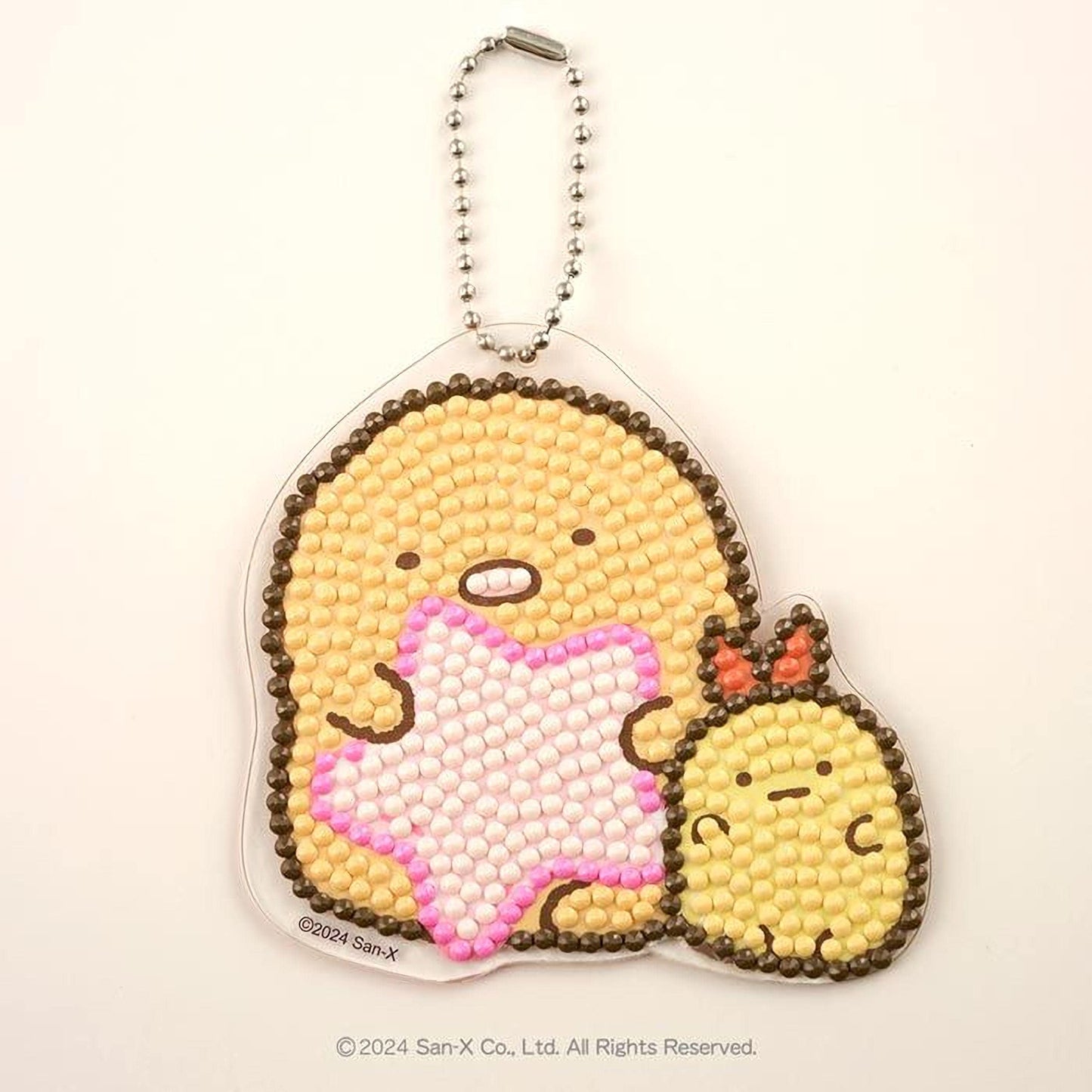 A keychain with a design of two cartoon characters, one larger and one smaller, made of colorful beads or dots.