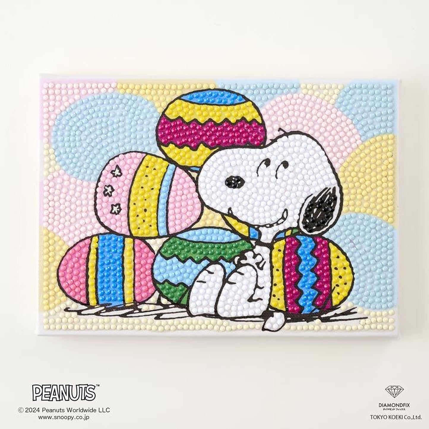 A collage of colorful Easter eggs, featuring the character Snoopy from the Peanuts comic strip, surrounded by a vibrant background.