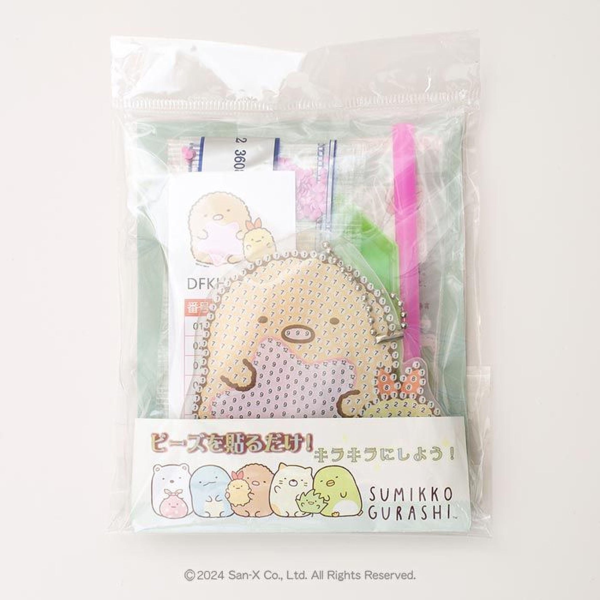 a package with a clear plastic bag, which appears to be a gift or a product. The package features a cartoon character and some text in Japanese.