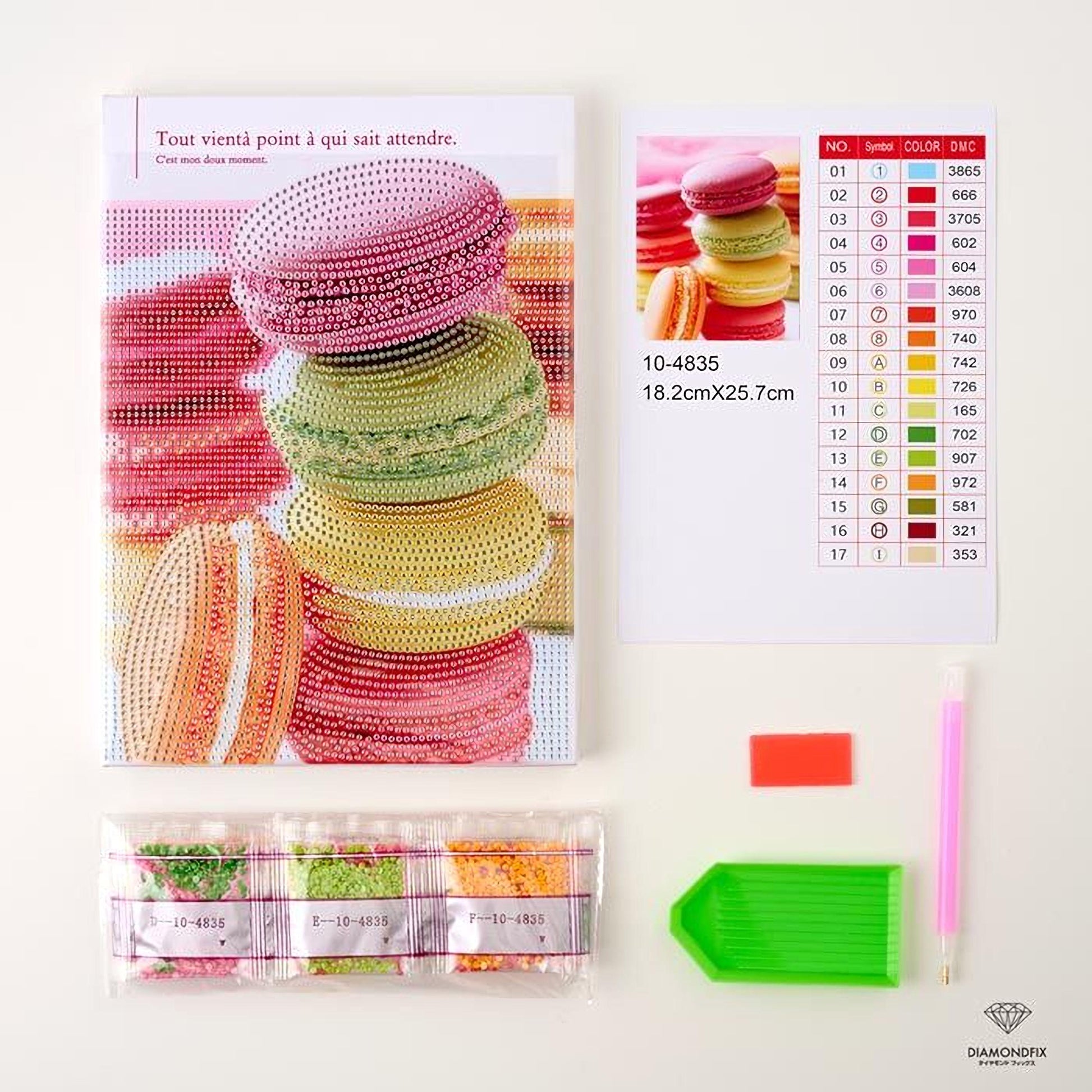 a variety of items related to a craft or DIY project, including a large book with a colorful cover, a set of diamond tools, and a color chart.