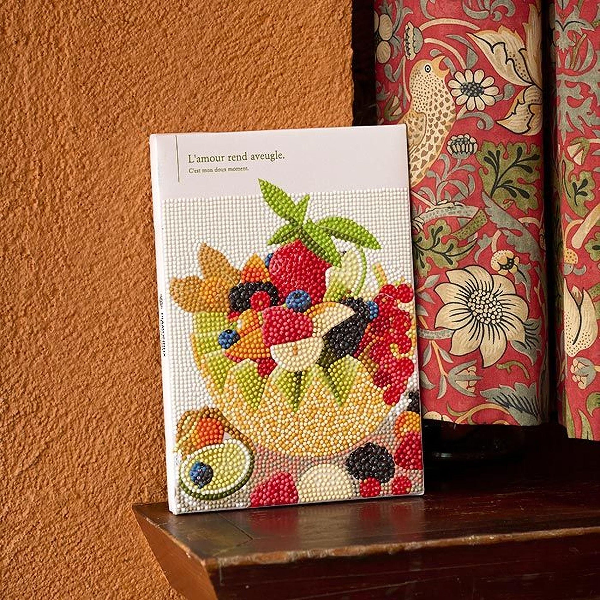 a book cover with a vibrant and colorful design of fruits and vegetables, including a bowl of berries and a variety of other produce.
