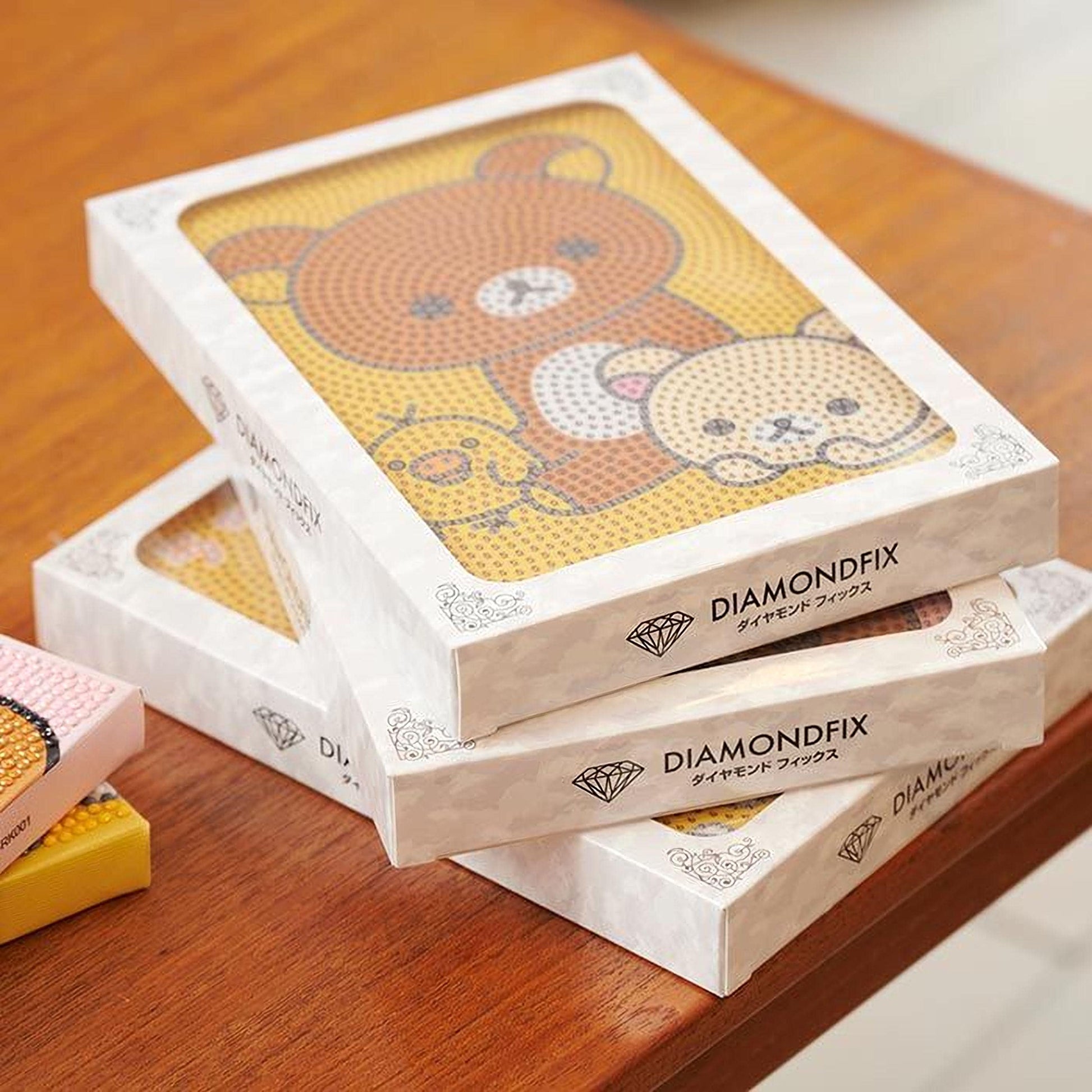 a stack of three white boxes with a colorful design featuring a bear and a dog on the front.