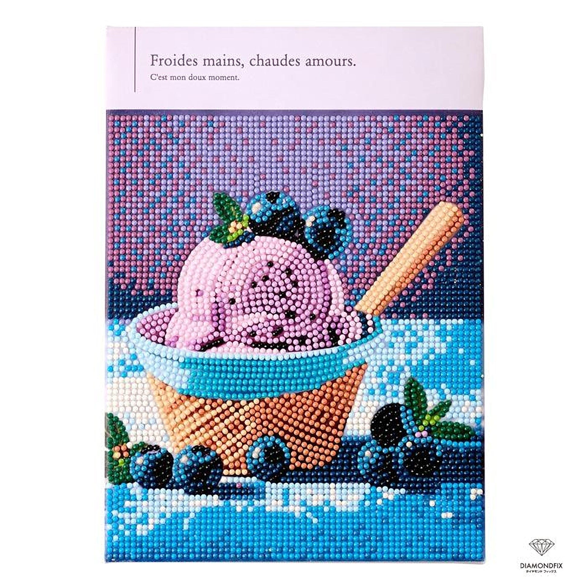 a bowl of ice cream with blueberries, and there is a spoon in the bowl.