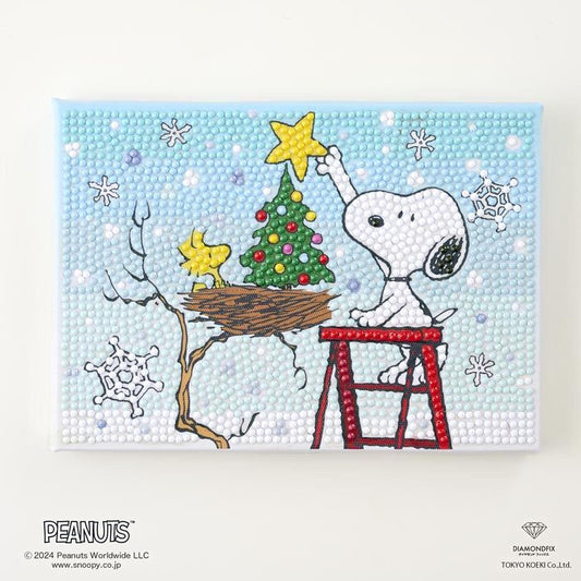 A Peanuts-themed painting depicting Snoopy placing a star on a Christmas tree, with a bird's nest nearby.