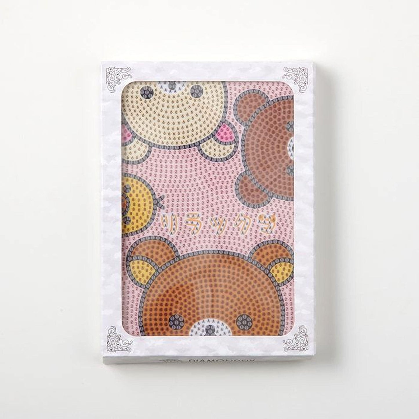 a white box with a decorative border, containing a picture of three cartoon bear faces.