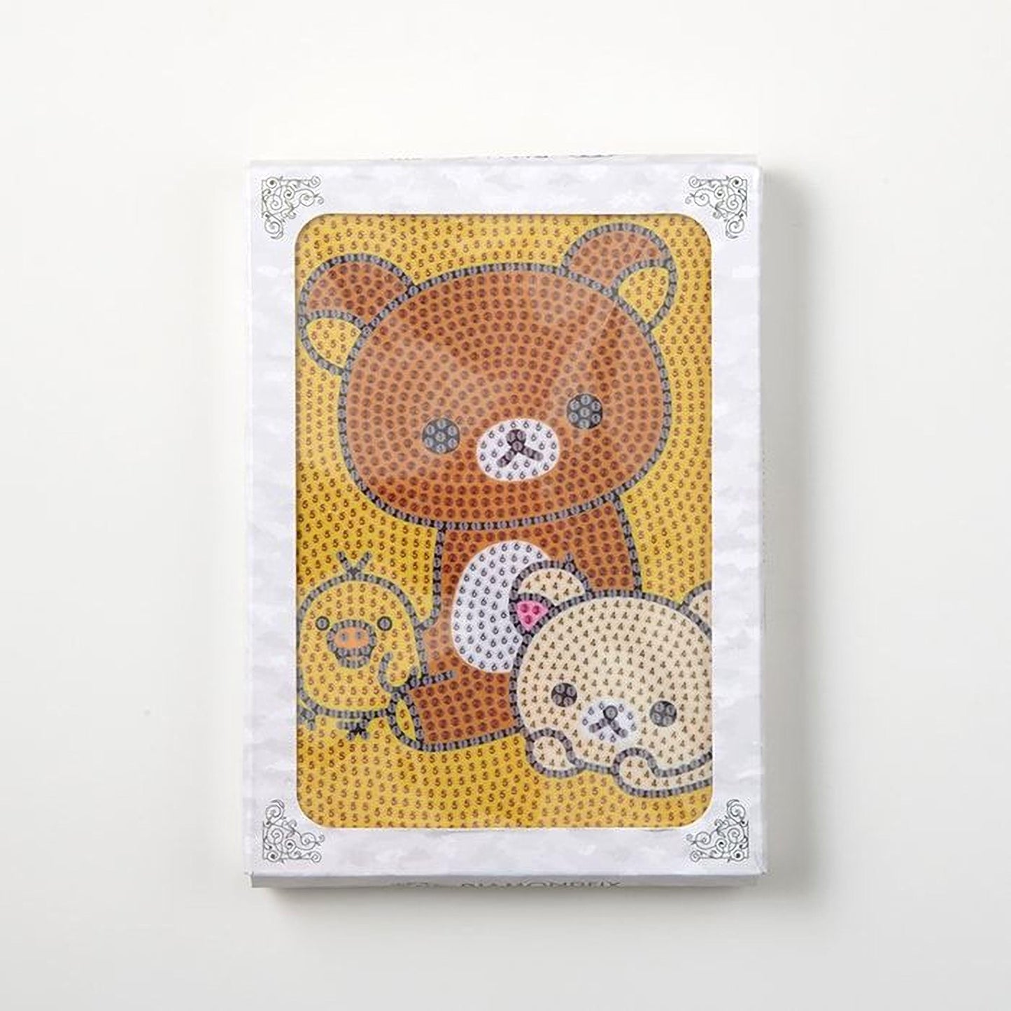 The image is a framed picture featuring a brown bear and two other animals, likely a duck and a cat, set against a yellow background.