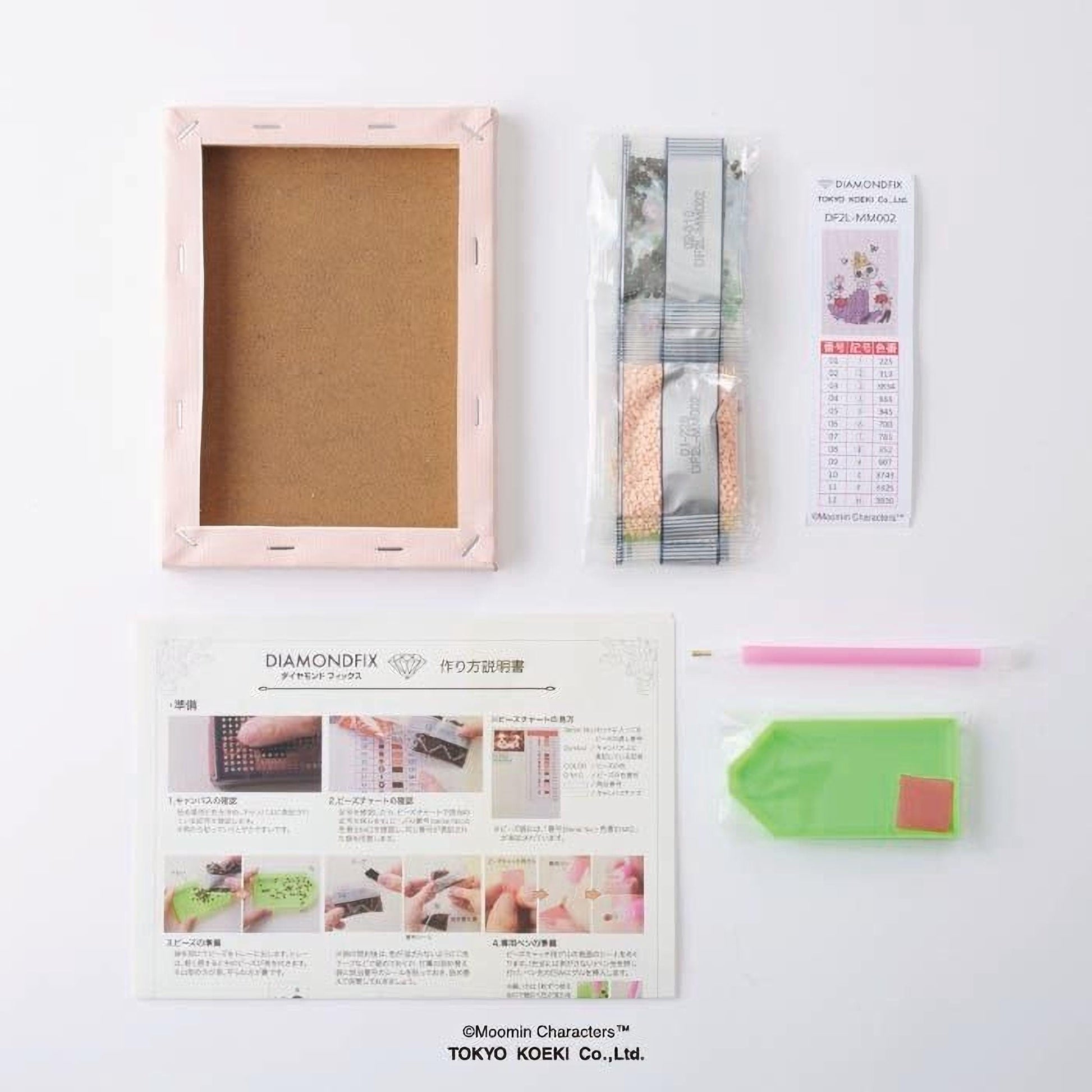 various items related to a DIY project, including a blank canvas frame, a set of diamond-shaped tools, a guidebook, and some other materials.