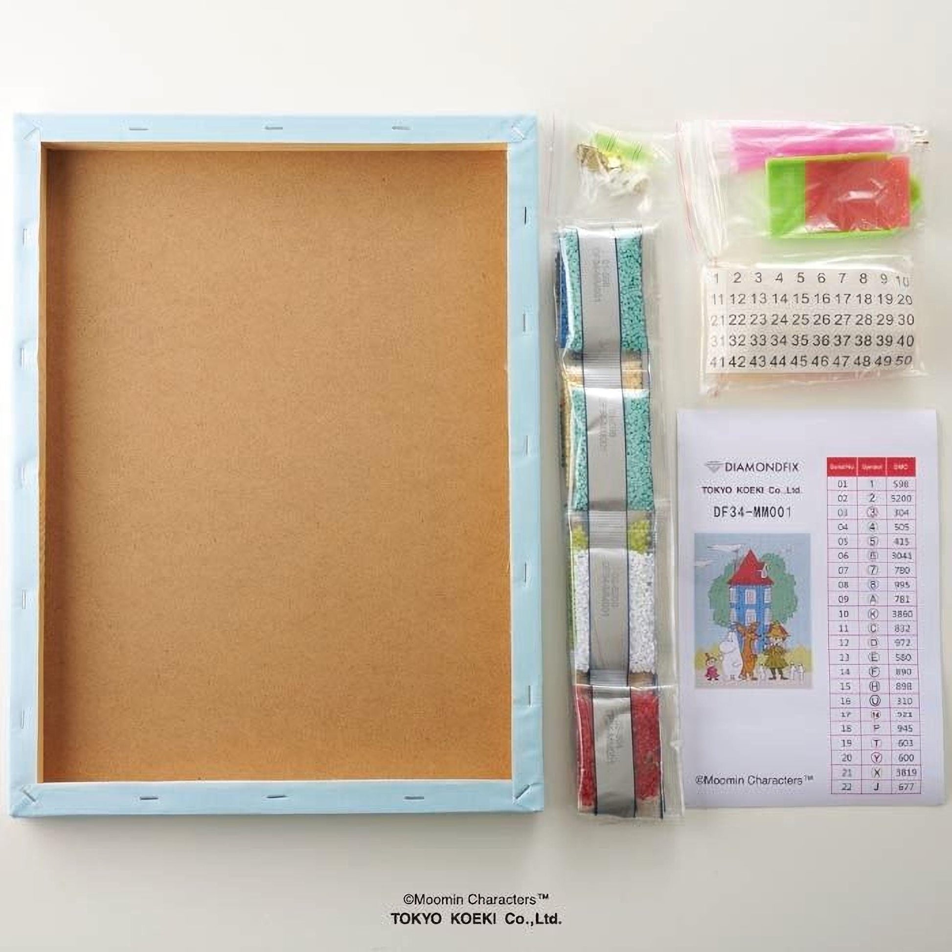 a blank canvas frame, a set of diamond-like objects, and a set of instructions or a guide for assembling the items.