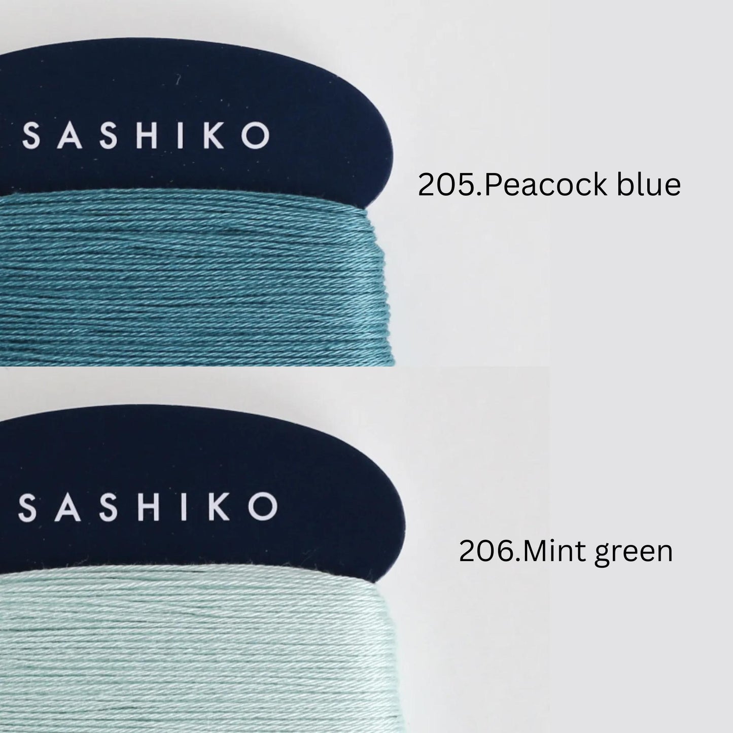 two spools of thread, each with a different color: one labeled "SASHIKO" in white text on a dark blue background, and the other labeled "206.Peacock blue" in white text on a light blue background.