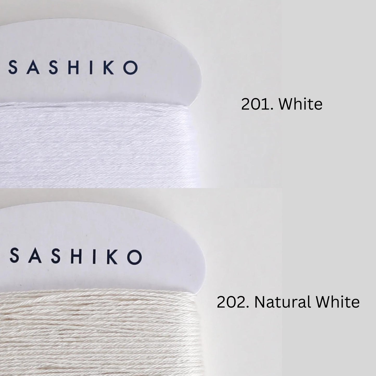 two spools of yarn, each with a different color: one labeled "SASHIKO" in black text on a white background, and the other labeled "201. Natural White" in black text on a white background.